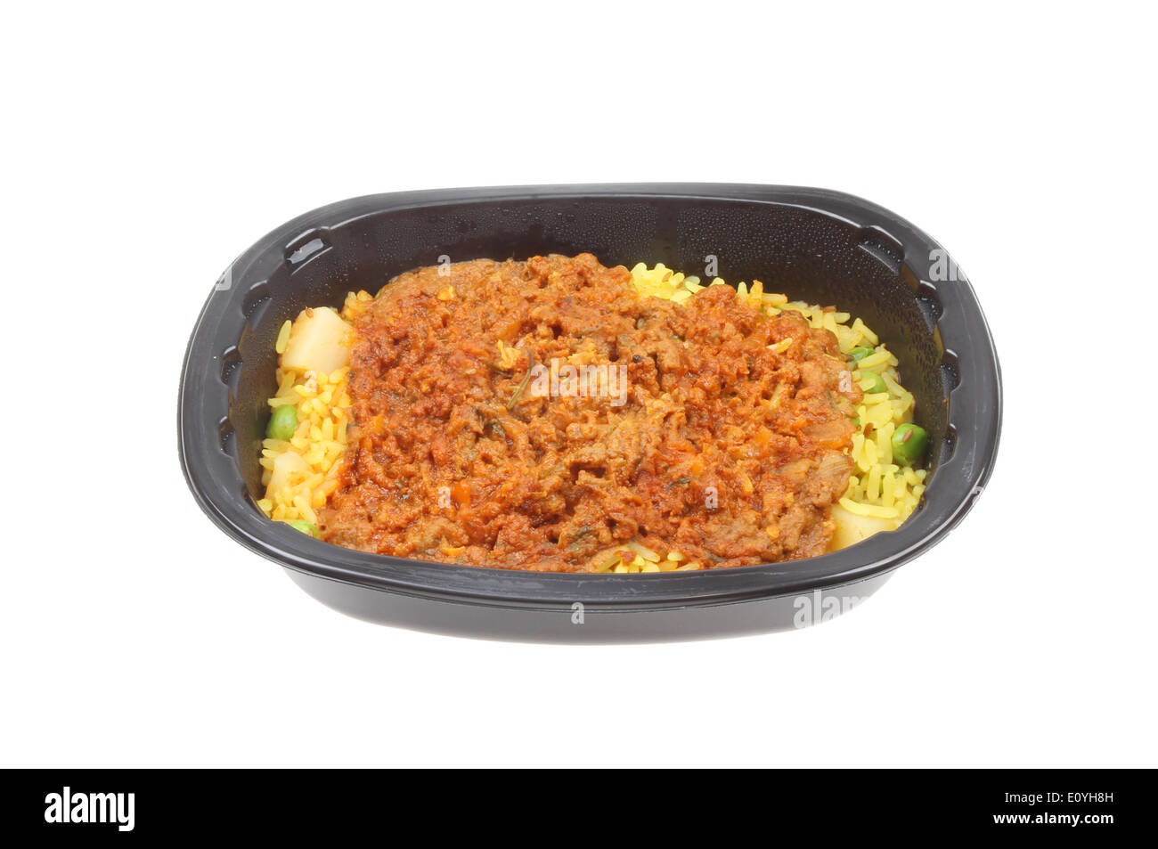 Convenience meal, lamb biryani, in a plastic tray isolated against white Stock Photo
