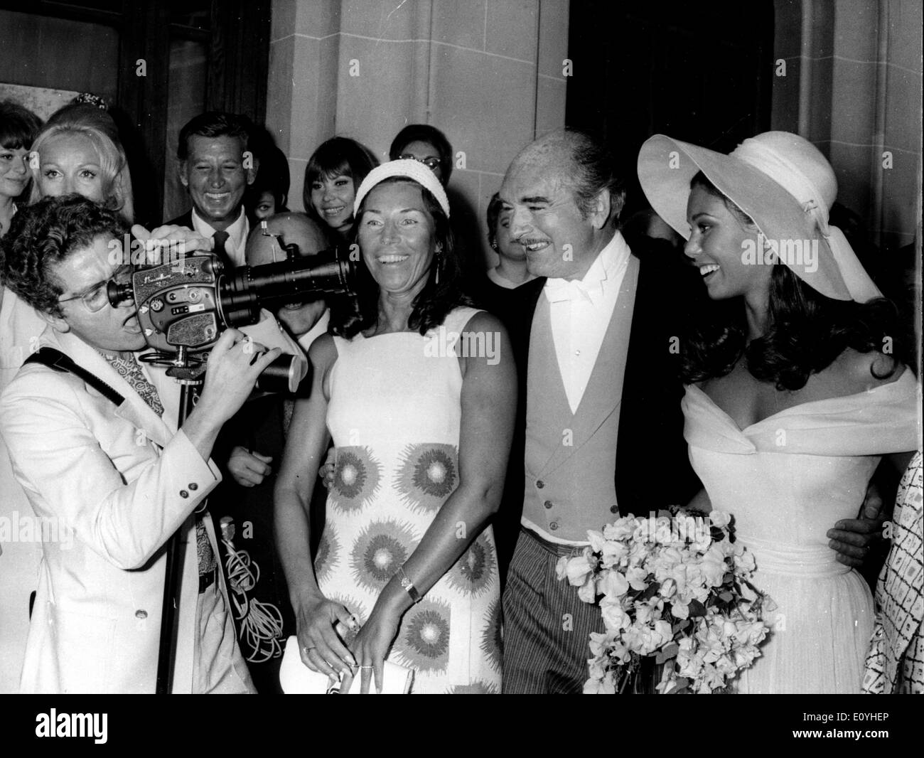 Jun 05, 1970; Paris, France; The famous French magnat EDDIE BARCLAY got marry for the fourth time at the Marie VIII in Paris with the young 18 year old BEATRICE CHATELIER. The picture shows the film producer DARRY COWL (L) filming the just married after the ceremony. Stock Photo