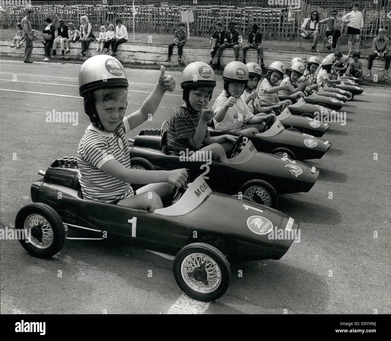 Jun. 06, 1970 - The RacJunior Grand Prix'' Race at Crystal palace: Britain's young sapiring drives took party today in the Rac ''Junior Grand Prix''. The Competitors were at the Controls of ''pedal-powered'' miniracing cars as they made a 75-yards dash down a section of the motor racing circuit at Crystal Palace, normally used by the experienced racing drivers. The Winners prize was the car he drove to victory, and the race was open to boys and girls aged 6 and under. Picture shows: The Young competitors give the ''Thumb-up'' sign as they line up for the start of the race. Stock Photo