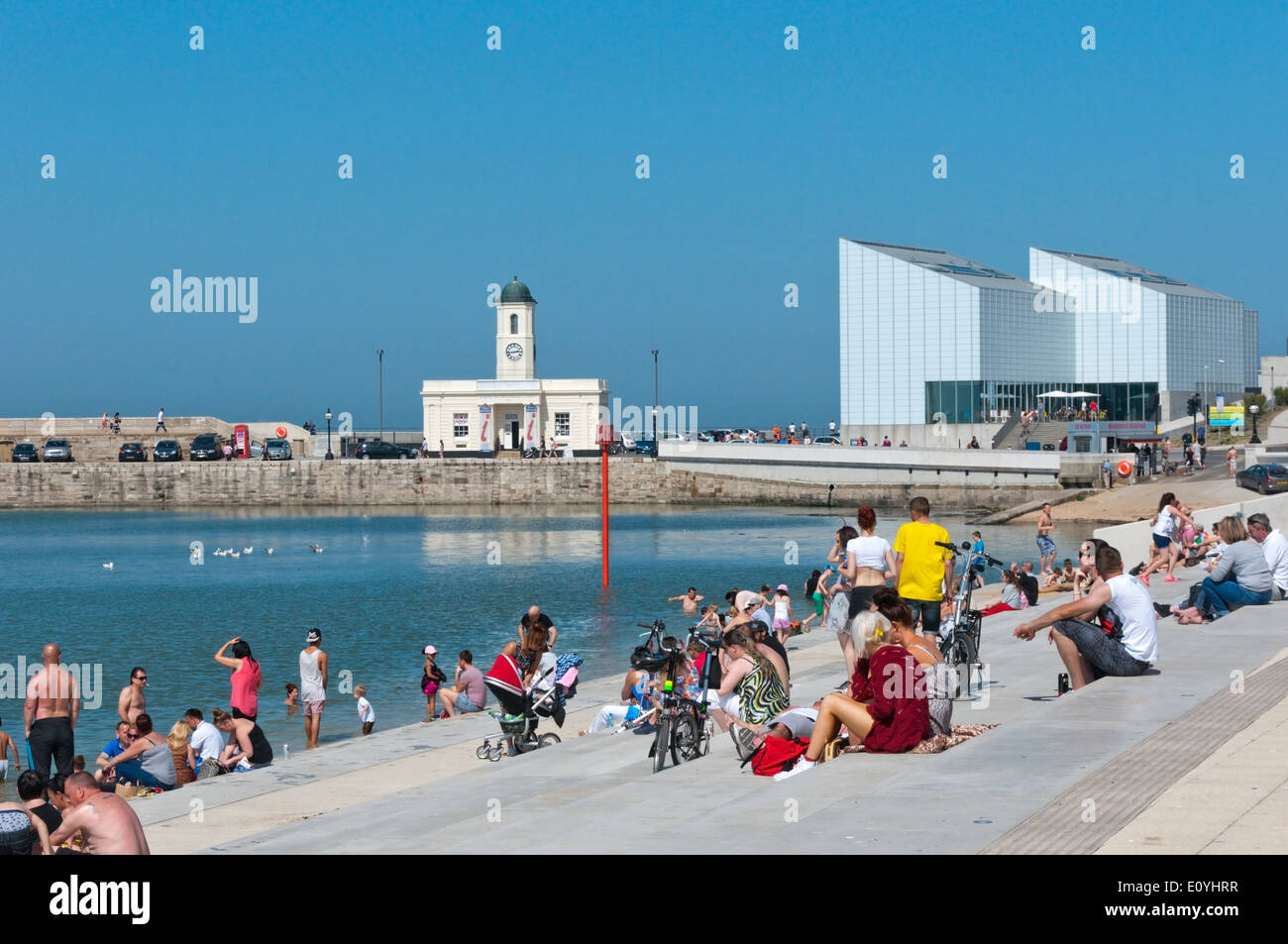 Sunbathers on the new promenade in Margate, Kent. Stock Photo