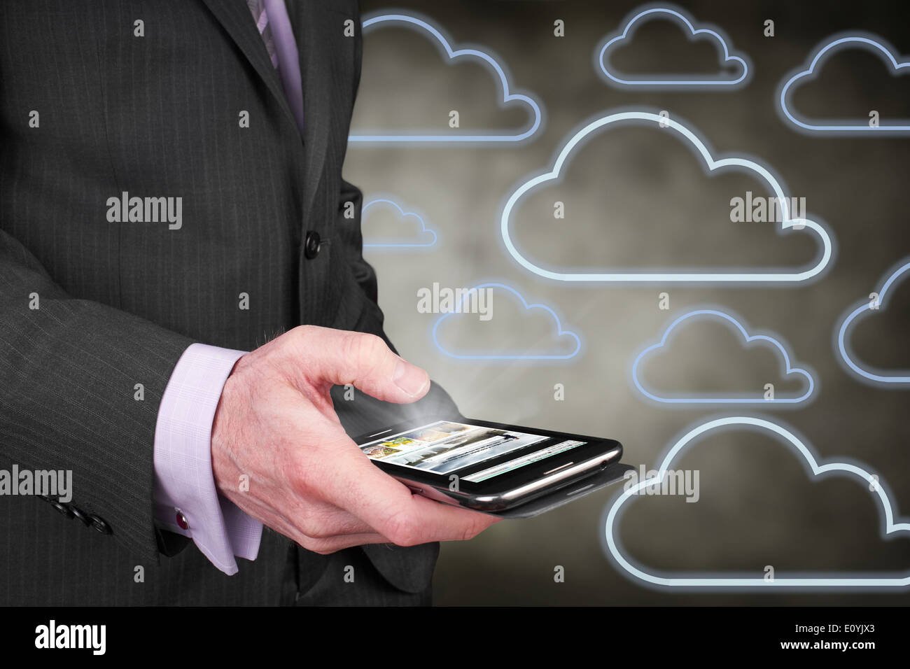 A businessman accessing data on the move over the internet from his mobile phone. Stock Photo