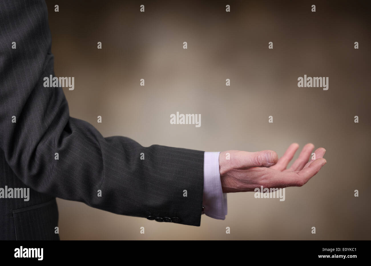 A businessman reaching out to offer assistance. Stock Photo