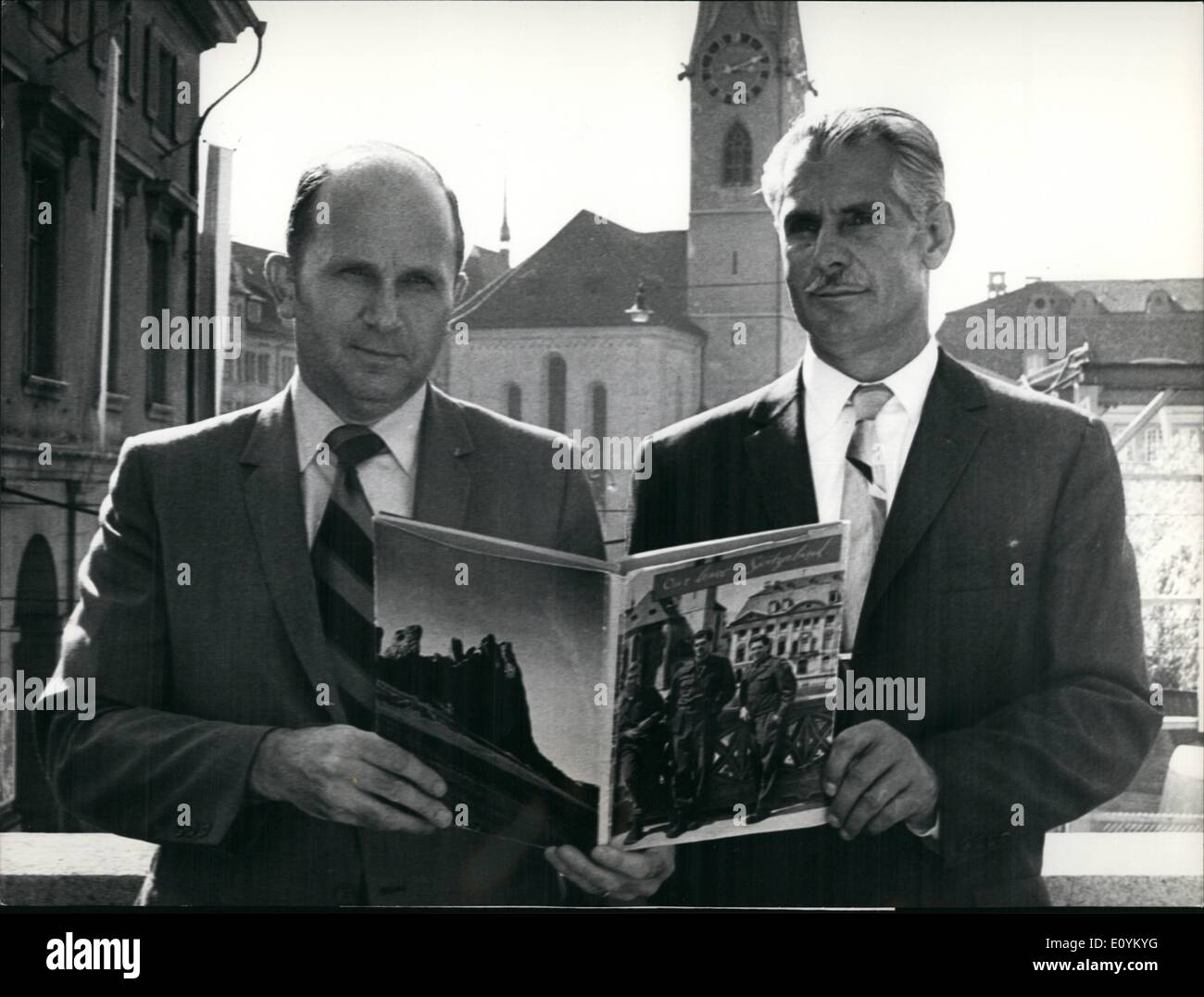 Sep. 09, 1970 - 4 memory-trip for GI's 25 years ago 450,000 US-Army-Leaves stayed in Switzerland. For this ''silver anniversary'' the Swiss Tourist Center explored two of the three US-soldiers, who figured on the front page of a memorial-book ''Leave in Switzerland'', and invited them to a memory-trip in Switzerland. On this way the GI's can show to her families the places they visited 25 years ago after the war. Photo Shows:The two ex-GIs Jesse H. Ellsworth (left) and Steve Marcinek (r) with the memorial-book. Stock Photo