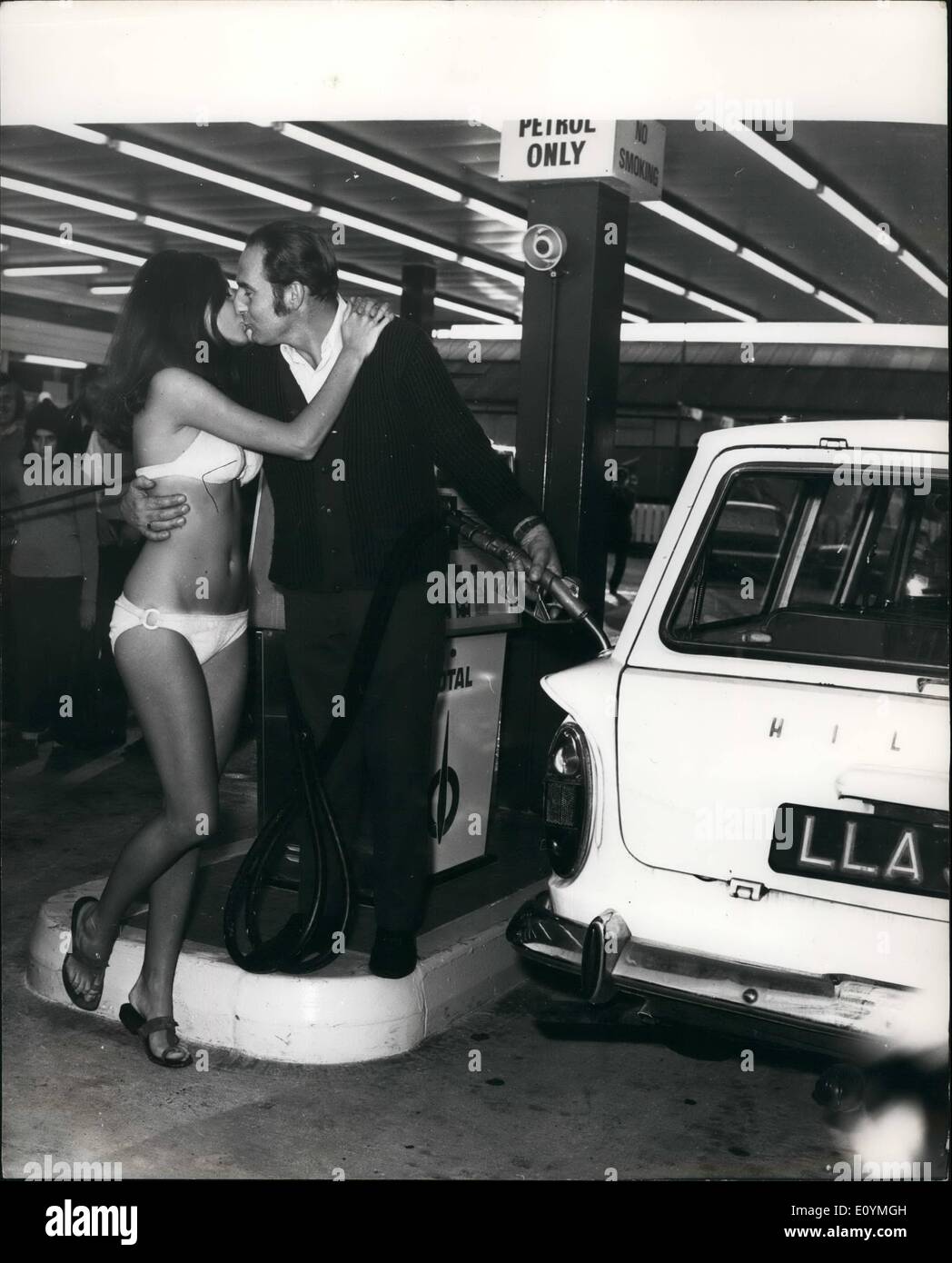 Oct. 10, 1970 - A kiss for Petrol: Motorists got a nice change today, when they drove into the new petrol station at Acton Vale, London after they filled up with petrol pump attends dresses in bikinis. Photo shows Fred Munro from Perivale, London is seen being kissed by lovely 25 year old Ann Collins after the opening of the garage today. Stock Photo