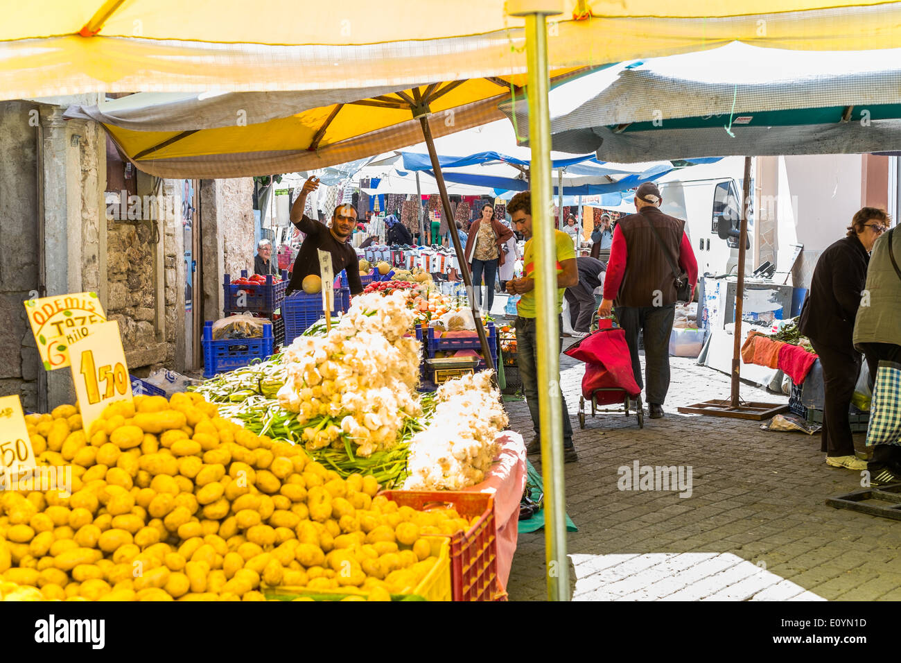 The weekly Tuesday market in Foca, Izmir District, Turkey, stall holder waves to attract customers. Stock Photo