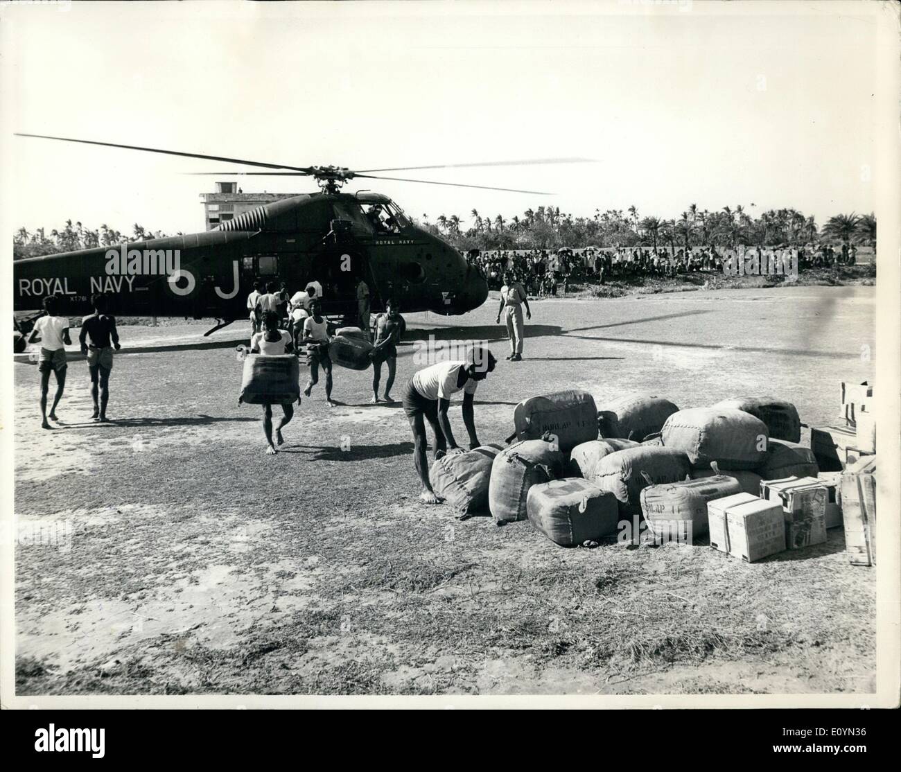 Nov. 11, 1970 - Willing Hands: Patuikhali, East Pakistan. Pakistanis were all too willing to unload stores from a helicopter from Britain's 847 Naval Air Squadron after it had landed at Patuikhali with relief supplies for survivors of East Pakistan's cyclone disaster. The helicopter flew in from the British assault ship Intrepid, one of the four-vessel British combined services task force which anchored in the Bay of Bengal, November 245th, to begin operation Burlap for the relief of the cyclone survivors. Stock Photo
