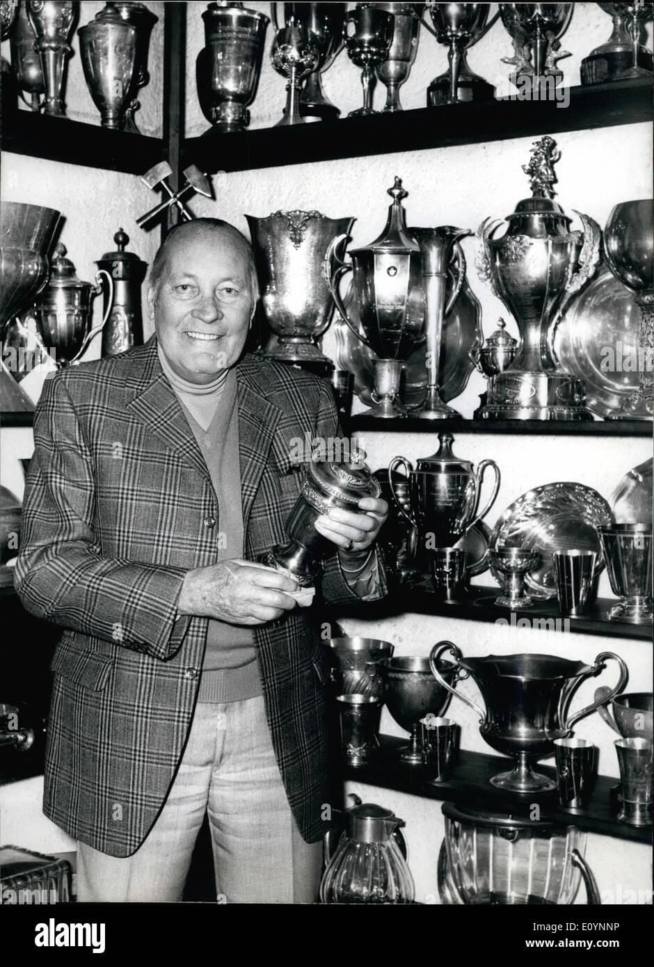Dec. 18, 1970 - Racing-driver Hans Stuck 70 years old: In front of all his cups (photo) Hans Stuck remembers all his former successes. On December 27th he can celebrate his 70th anniversary in his home in Obergrainau (Germany) - in the best of health. Hans Stuck, born in Freiburg, became active at the age of 22. He won his first race. Four years later he won the European mountain competition - after that his career started. From 1932 he was driver at Daimler-Benz, two years later he went to Auto-Union to drive one of the very quick ''Silberpfeil''. 1934 he won his first Grand-Prix in Germany Stock Photo