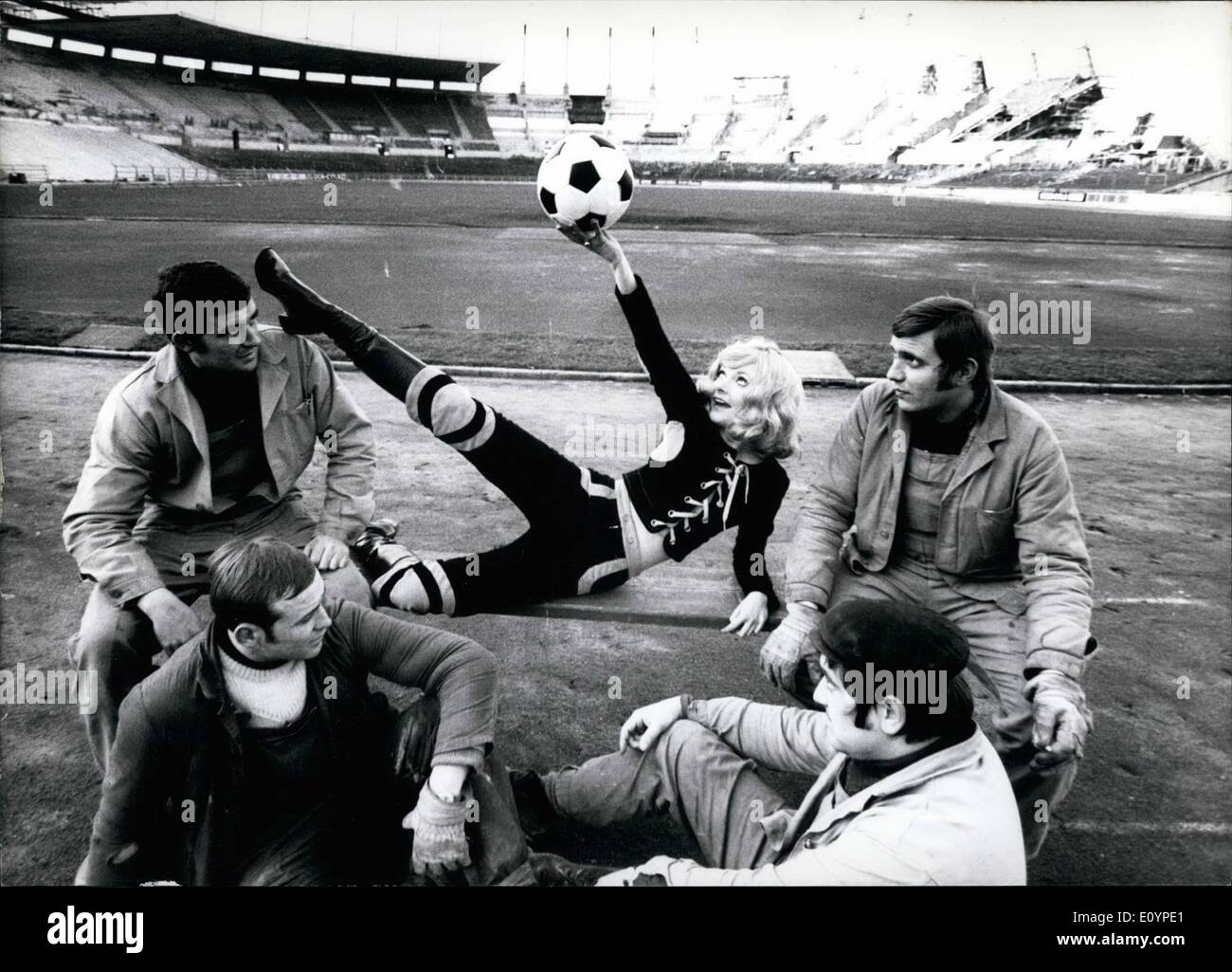 Feb. 02, 1971 - Pretty Elke Sommer: likes to play with the ball - and therefore one can well understand that she found the first rugby-suit for ladies in Dusseldorf (Germany). As he didn't find a rugby-ball she demonstrated with a ''normal'' ball her sportsmanship. Elke is being admired by workers (photo) who work at the extension of Dusseldorf's stadium which shall get 70 000 seats, and which will certainly be finished 1974 for the world championship. Stock Photo