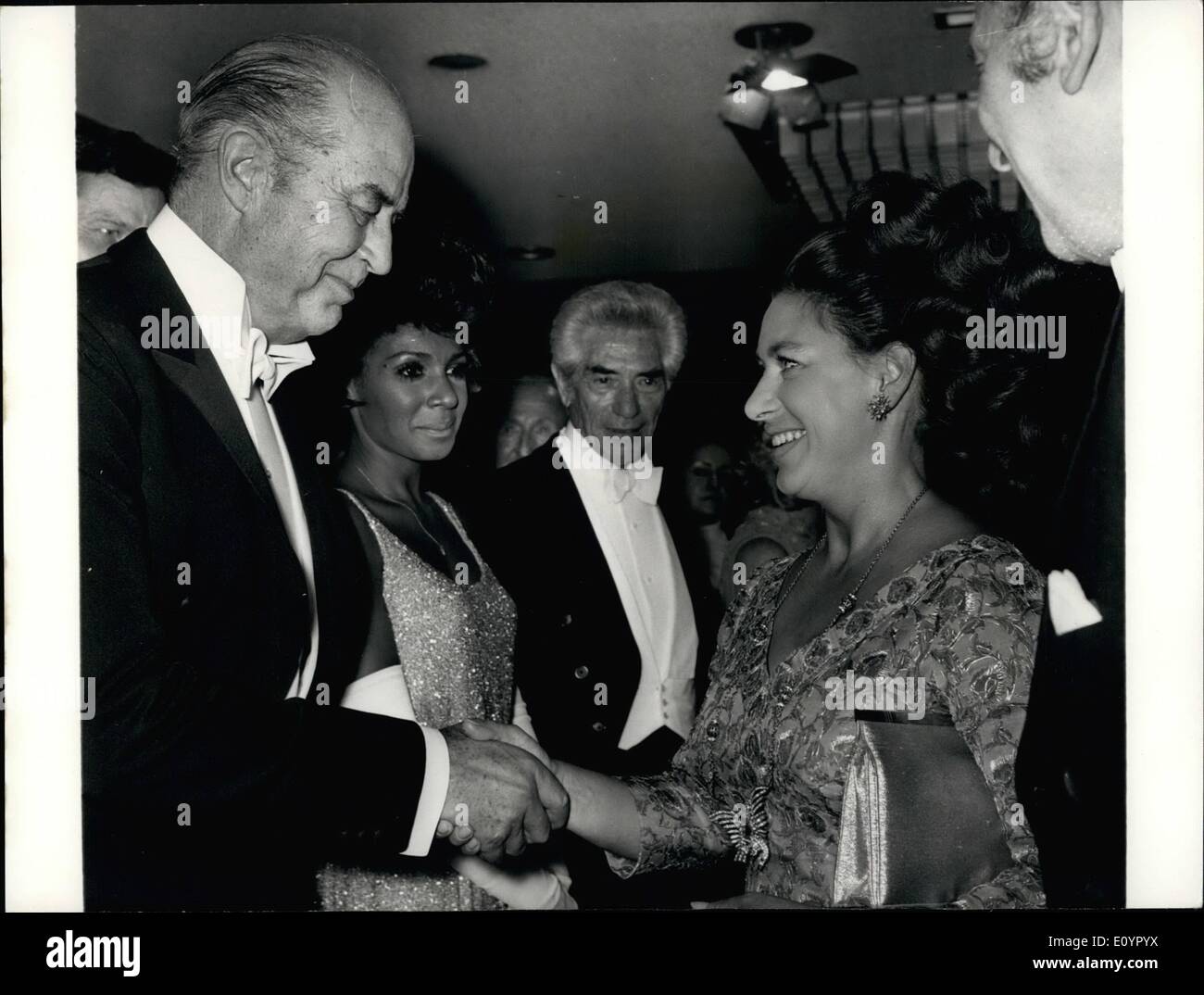 Mar. 03, 1971 - The Queen mother and Princess Margaret attend the Royal film Premiere. Photo shows Vetern film actor Ray Milland shakes hands with Princess Margaret in the foyer of the Odeon Theatre, Leicester Square, London, last night following her arrival to attend ''Love Story'', the royal film performance for 1971/ In the centre is British singer Shirley Bassey, who sings the sound track music to the film Stock Photo