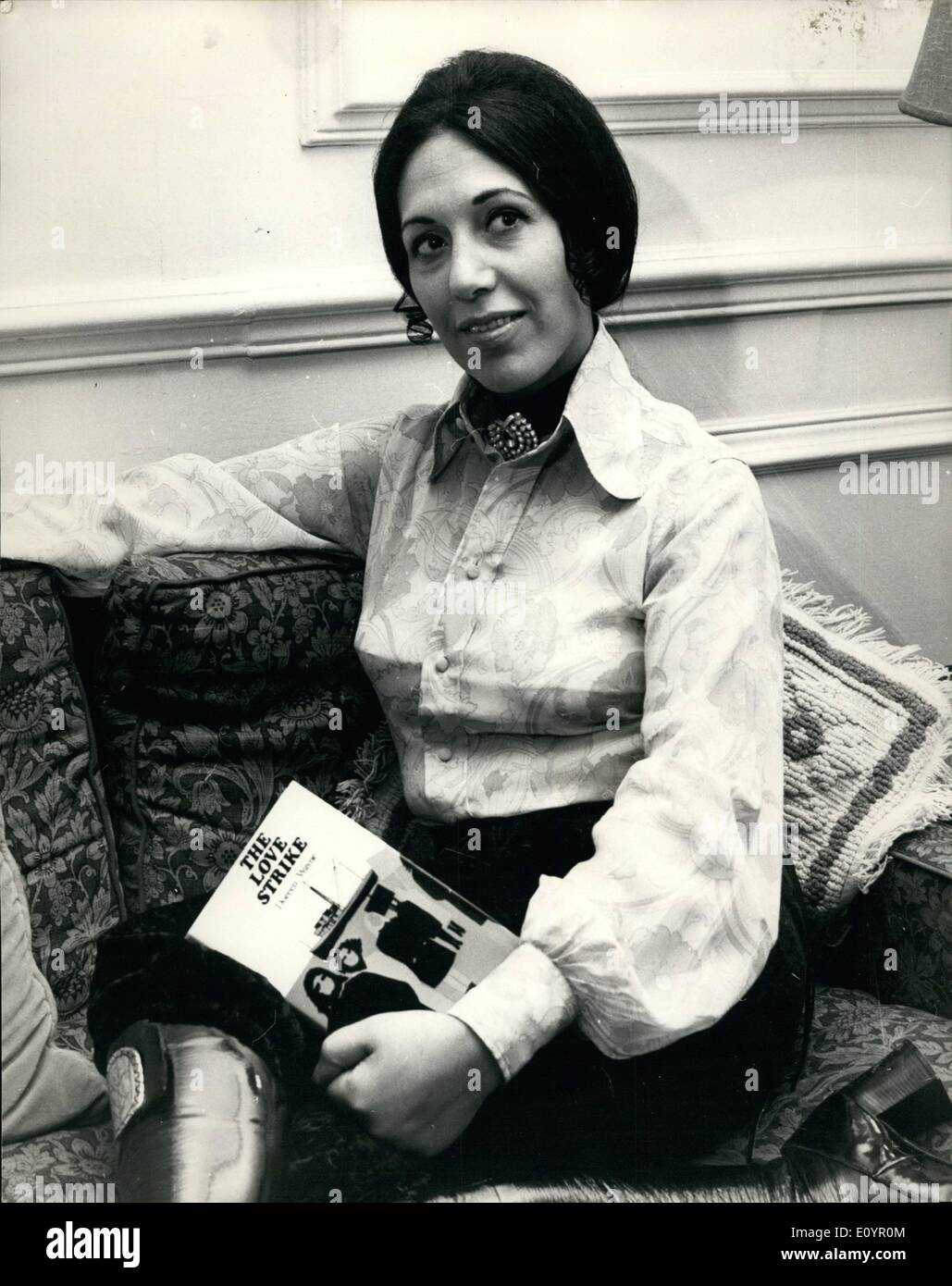 Mar. 03, 1971 - ''The Love Strike'' Authoress in Lonodn: Doreen Wayne, Manchester born wife of American actor/producer Jerry Wayne, has arrived in London from scriptwriting in Hollywood for the publication of her new book ''The Love Strike'', published by W.H. Allen on Monday, 15th March. Photo Shows Doreen Wayne pictured with a copy of her new book, in London today. Stock Photo