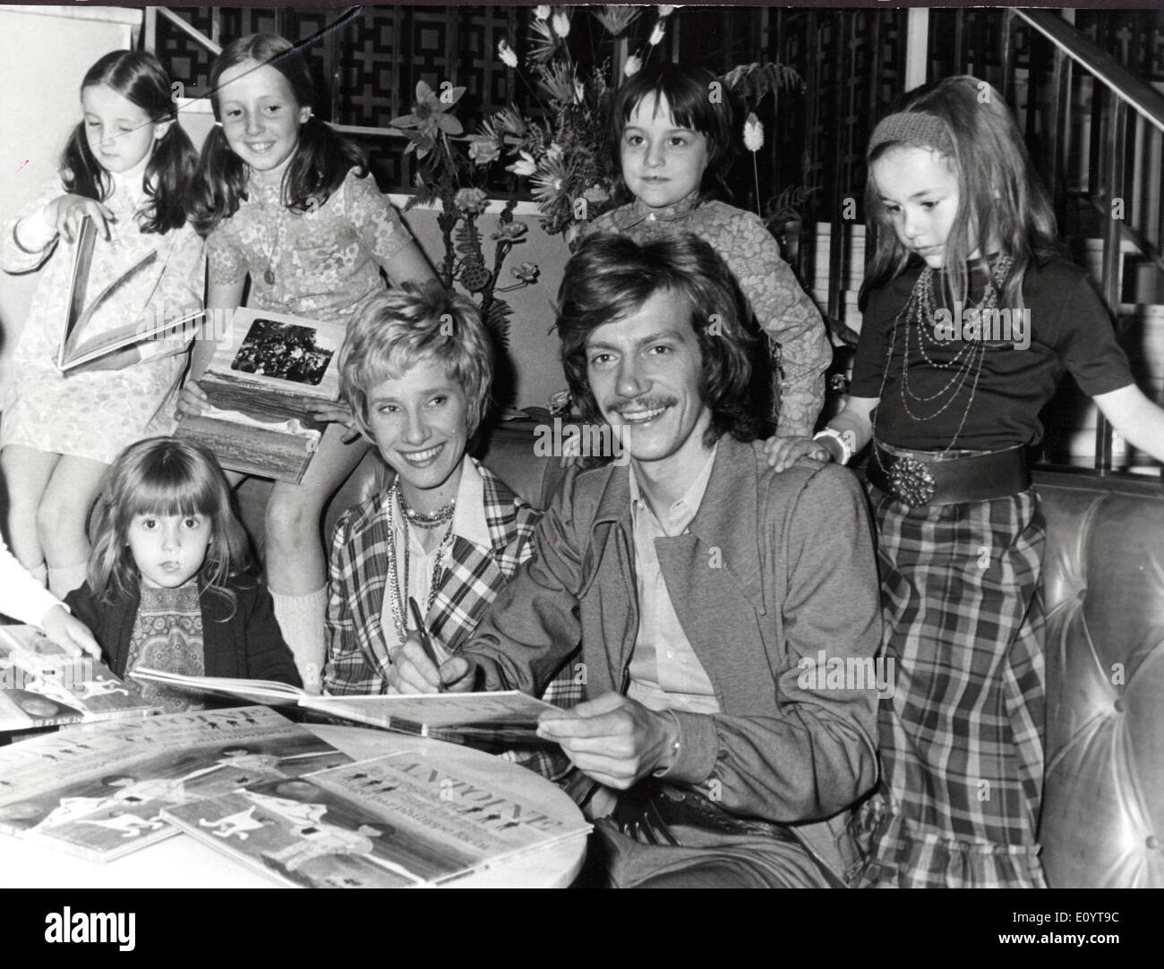 May 06, 1971; Paris, France; 'The President on the moon' new title of the child-book writen by the French singer ANTOINE CHEVALIER. Yesterday, Antoine was signing his books surrounded by several kids and the pretty DANIELE GILBERT, at a store close to Champs Elysees, Paris. The picture shows the young fans and Daniele surrounding the singer while signing his book. Stock Photo