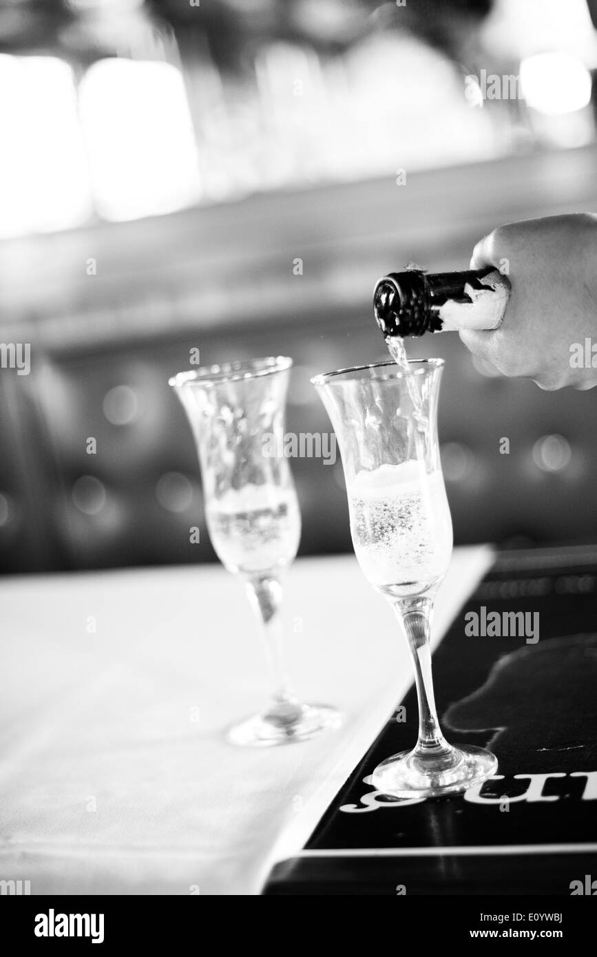 Black and White photograph of  champagne being poured. Stock Photo