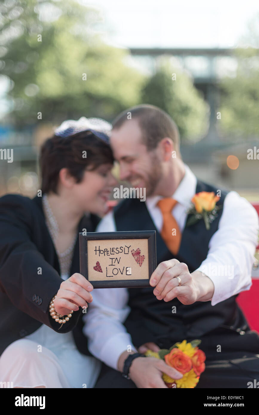 Couple with Happily in Love sign Stock Photo