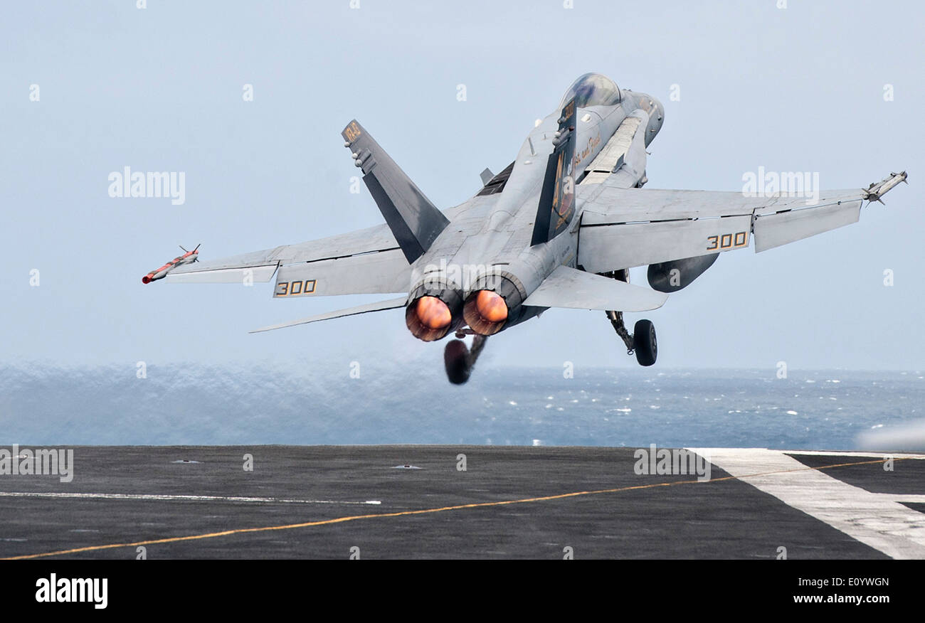 A US Navy F/A-18F Super Hornet fighter aircraft launches from the flight deck of aircraft carrier USS Carl Vinson May 19, 2014 off the coast of Southern California. Stock Photo