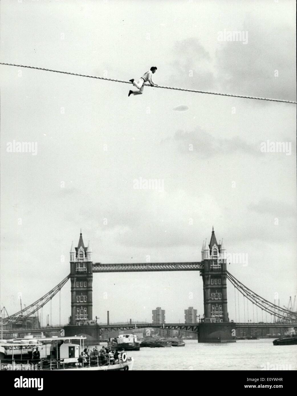 Aug. 06, 1971 - August 6th, 1971 The Charity tightrope walk that failed. 30-year-old Cologne Ã¢â‚¬Ëœspider-man' Franz Josef Burbach today made an attempt to make an 820-feet tightrope walk between two warehouse 60-feet above the Thames near Tower Bridge. But the attempt which was in aid of spastics failed after a series of mishaps. First his balancing pole was damaged so he tried to walk without it, but he didn't get very far, so he decided to crawl across, an only manage just over half way before falling off into the water Stock Photo