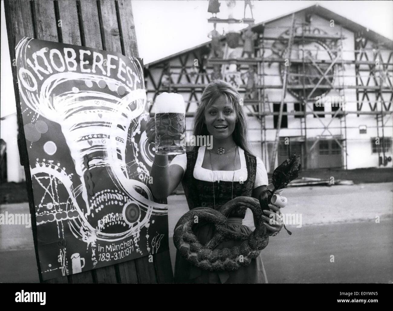 Aug. 08, 1971 - Preview-Photo To The Octoberfest 1971 In Munich Advanced... ... Christiane Rucker visited the Munich Beer Festival, because when the Oktoberfest starts officially she is busy, that means, she has to be in Vienna (Austria) for theater-rehearsals. Before the actress from Munich came to the fair-grounds, she thought, she would have to do without the traditional ''requisites'', but soon she found somebody who spend her the original ''Mug'' of beer, the chocolate heart and the giant pretzel. The official poster for the Beer-Festival is shown left on our photo. Stock Photo