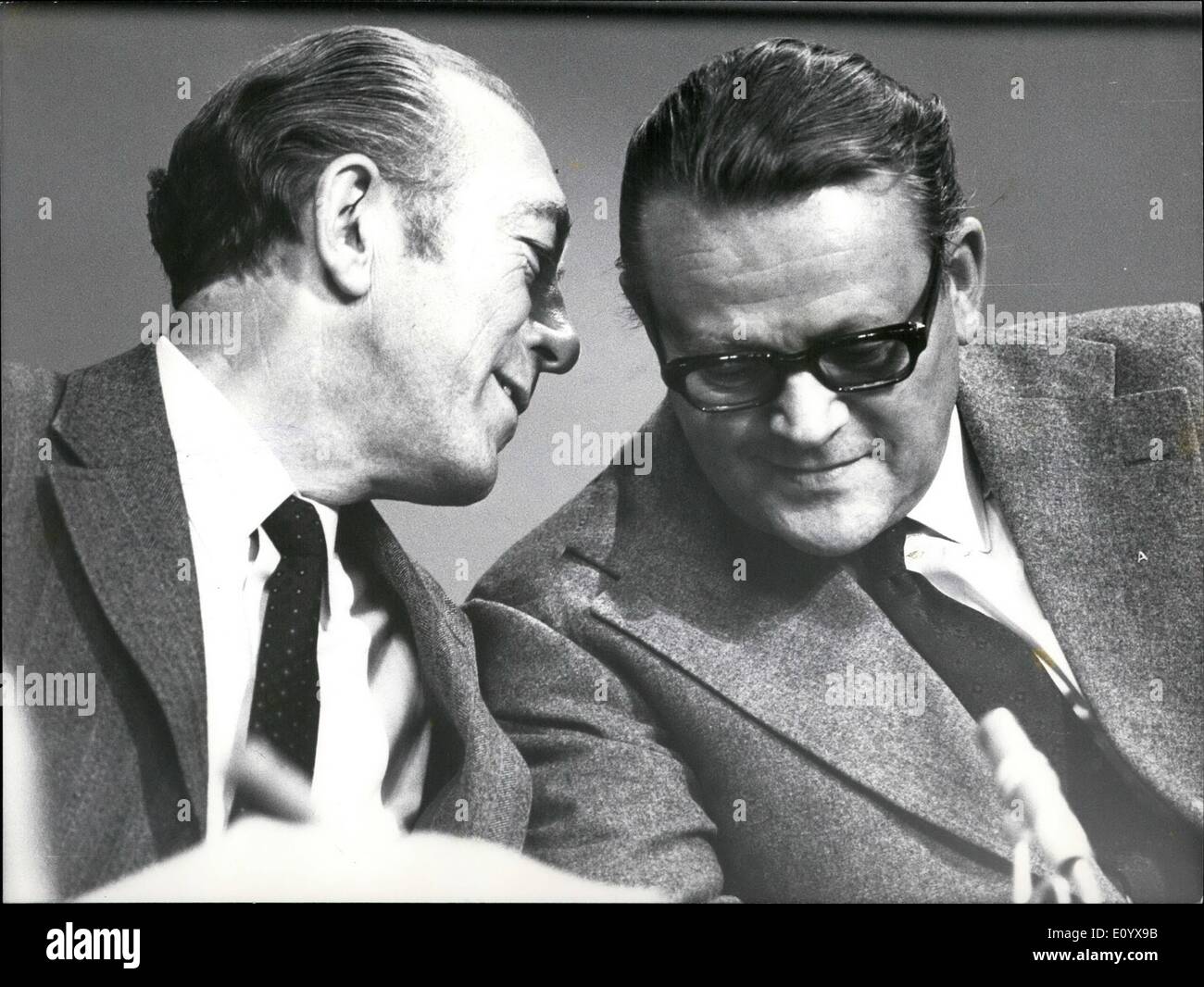 Sep. 09, 1971 - Danish Coalition Resigns. Prime Minister Hilmer Baunsgaard's centre right coalition government resigned today after 45 months in power. King Frederik asked Baunegaard to continue as head of caretaker government until parliament opnes on October 5th. Photo Shows: Prime Minister Hilmer Baunsgaard whispers in the ear of former Premier Jens Otto Krag, during last week's election in Denmark. Stock Photo