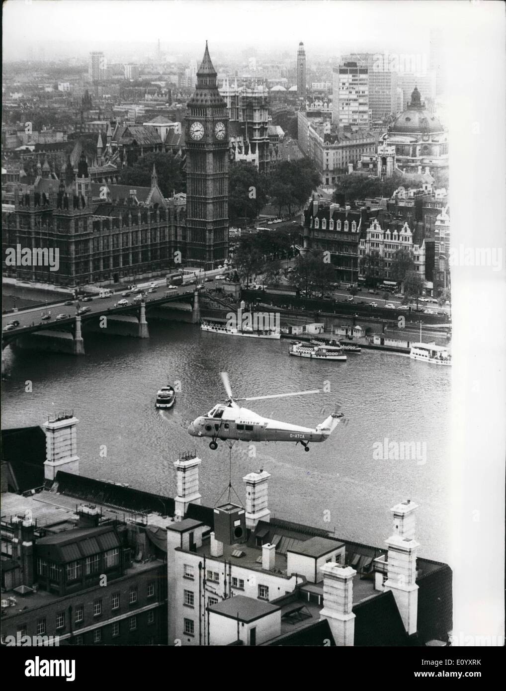 Oct. 10, 1971 - Helicopter Airlift At County Hall: The problem of how to lift two steel cooling towers, each weighing 1 1/2tons, on to the roof of County Hall, London, was solved today - by helicopter. The airlift took place when the two towers, part of the environmental control system for the Greater London Council's new computer suite was hoisted on the roof nearly 130ft above the Thames. The lift was made by a Wessex helicopter. The environmental system in the computer suite keeps temperature, humidity and dust at acceptable levels, to ensure efficient working Stock Photo
