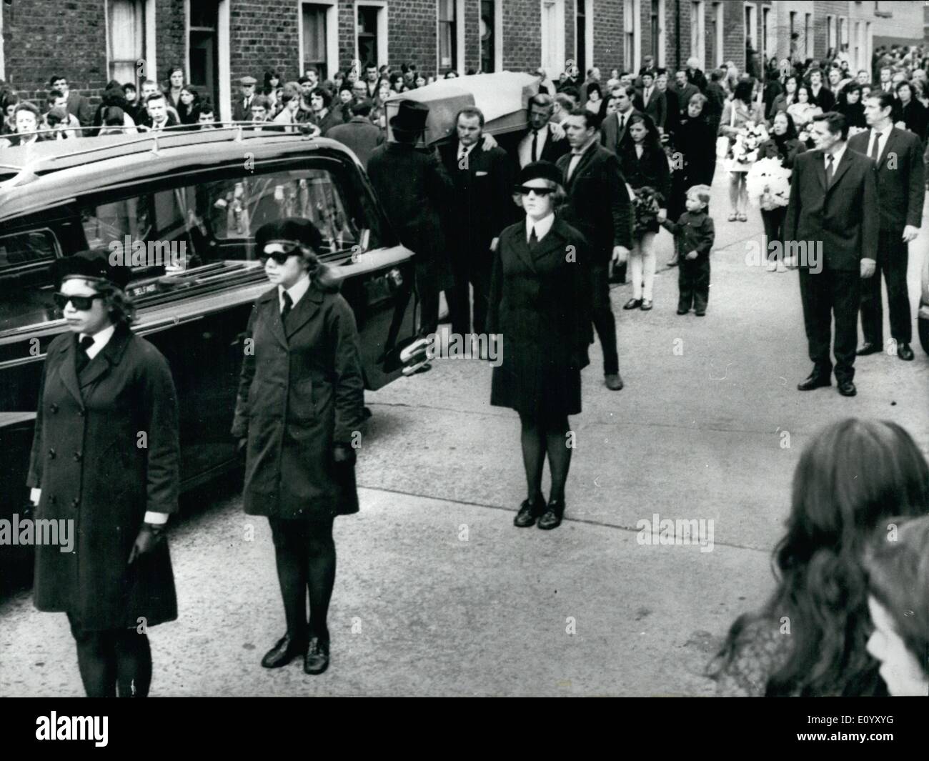 Oct. 10, 1971 - Funeral Of Shot Sisters In Belfast: In Belfast yesterday, teenage girls of the women's I R A, wearing black barets and dark glasses, slowmarched beside the Tricolour-draped coffins of two shot sisters, who were given a showpiece funeral. Nearly 10,000 Catholics lined the streets as the bodies of Miss Dorothy Maguire, 19, and Mrs Mary Mechan, 30, a mother of four, were carried to the traditional Republican plot at the city's Milltown cemetery. They were shot in a car by troops at the weekend. The Army said shots were fired at troops from the back window of the vehicle Stock Photo