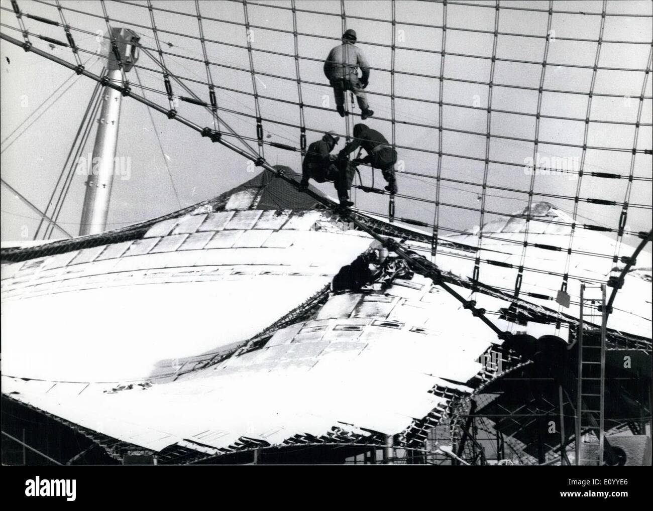 Nov. 11, 1971 - The Race Against Time: After Munich's first snowfall on November 19th, 1971, the international labour force works round the clock to complete all the Olympic stadium on schedule, Opening day is August 26th, 1972. Phot Shows Workmen are busy on the roof of the main stadium - in the back-ground the almost completed roof of the all-purpose stadium covered by Munich's first snow on November 19th. Stock Photo