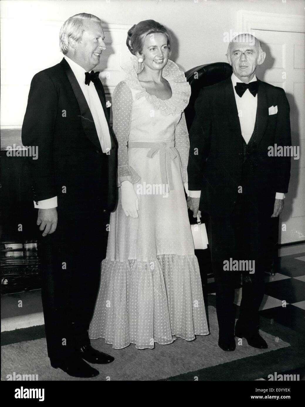 Sonia McMahon, wife of Australian Prime Minister William McMahon, wears a  double-split white evening gown, while first lady Pat Nixon wears a more  conservative gown as they walk towards the state dining