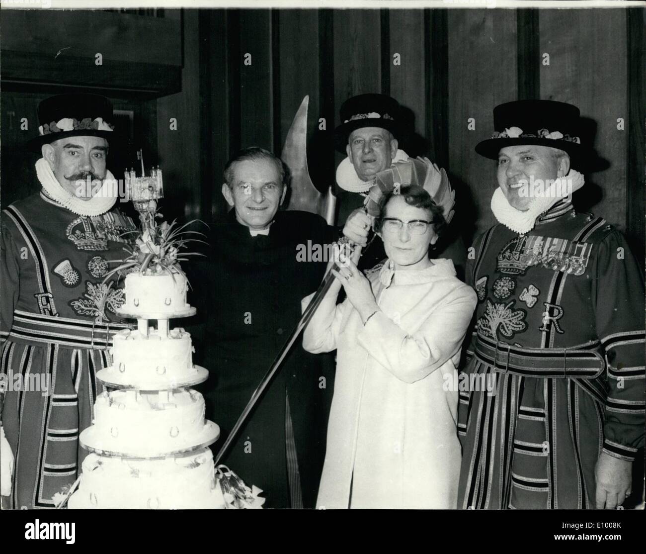 Jan. 01, 1972 - H.M Chaplain to the tower of London weds: Believed to be the first H.M Chaplin to be married while in office since the Tower of London was built the Rev. John G Nicholls was married today to Miss Dorothy Friend, of Carlton, Notingham, during the ceremony held in the Chapel Royal St. Peter Ad Vinculs, inside the Tower of London. Photo shows Watched by Yeoman Warders of the Tower of London, the Rev. John G. Nicholls and his bride Dorothy cut the wedding cake at the reception held at nearby Bakers Hall. Stock Photo