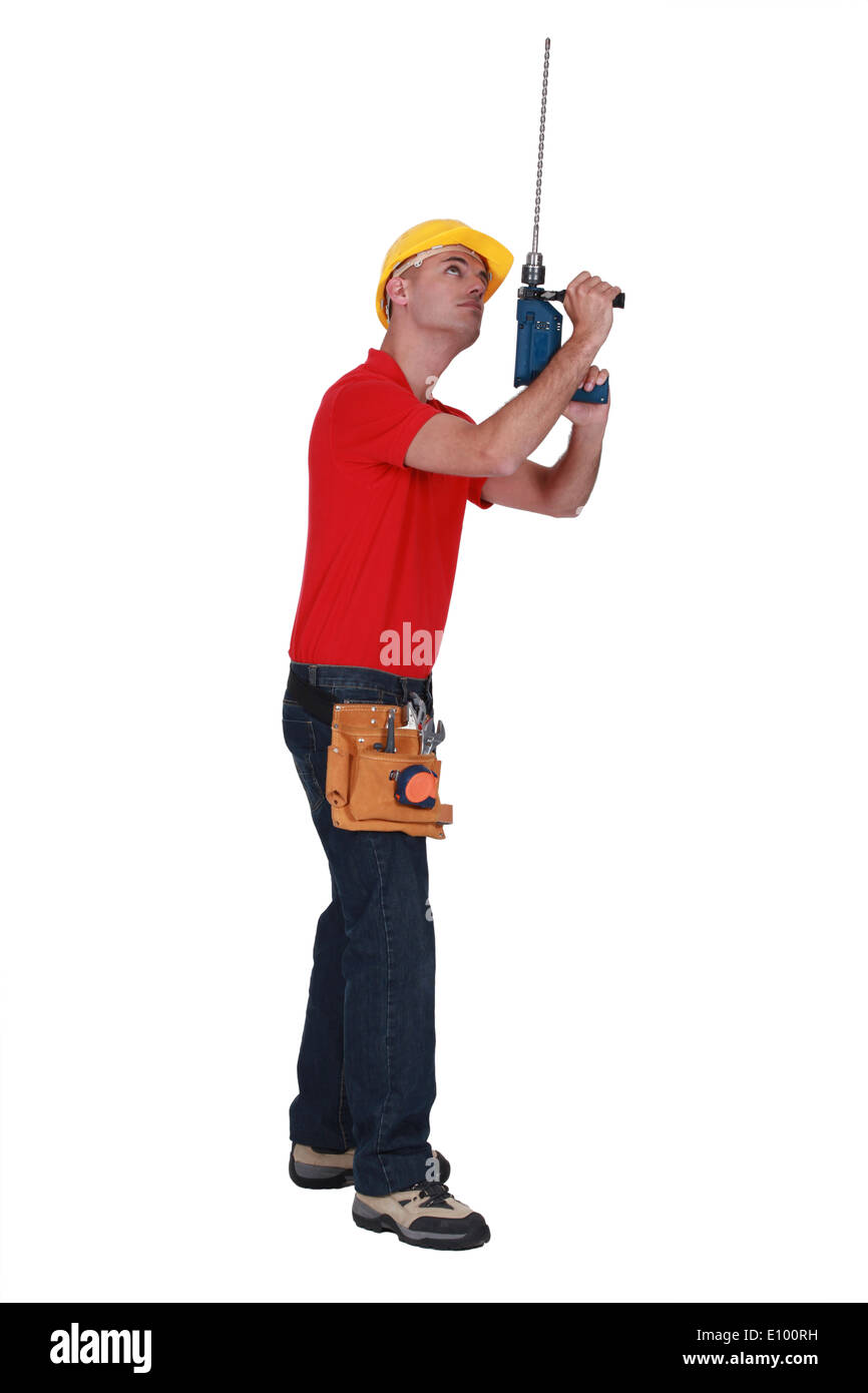 Tradesman adding an extension to his screw gun Stock Photo