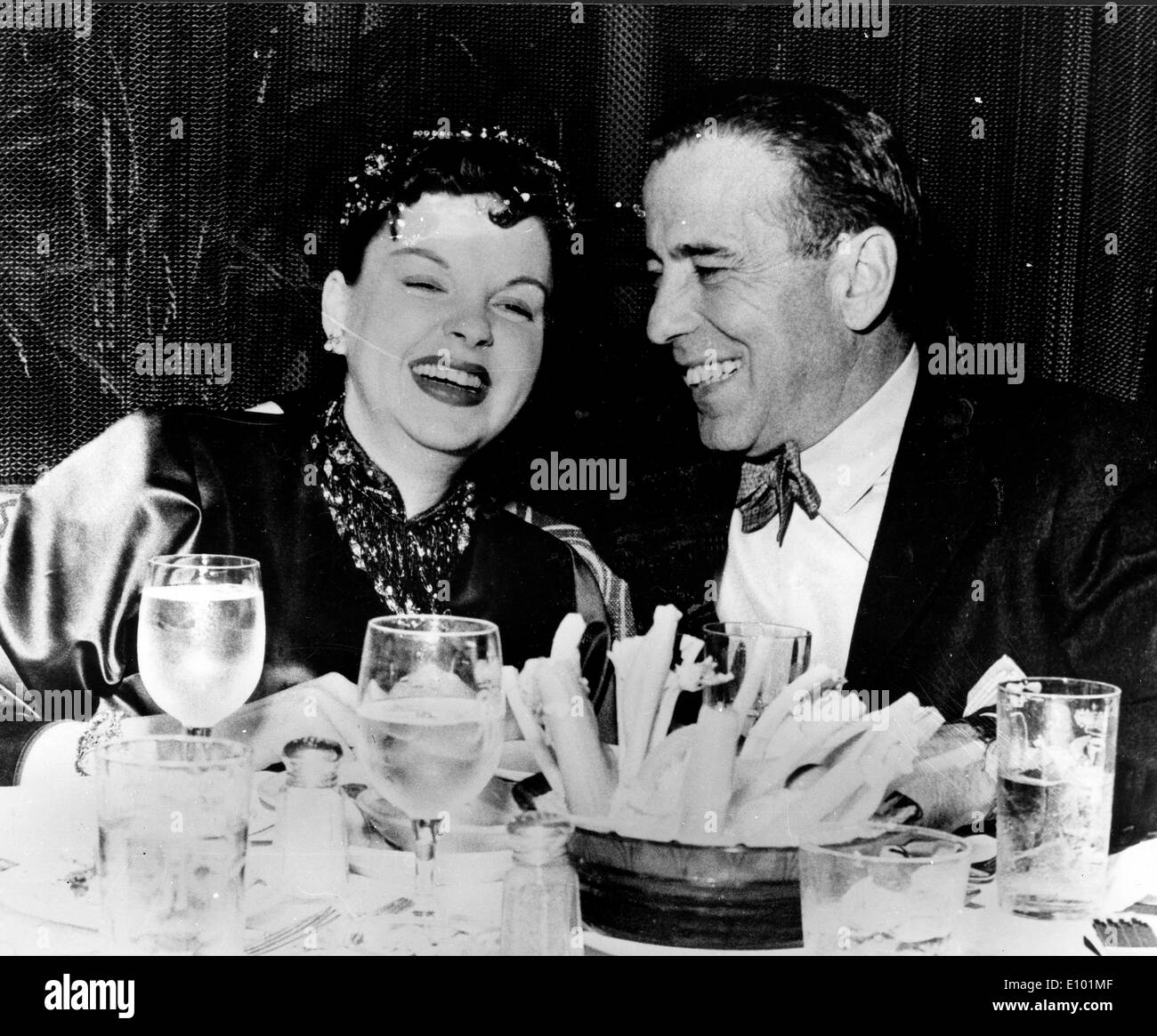 Actors Judy Garland and Humphrey Bogart dine together Stock Photo