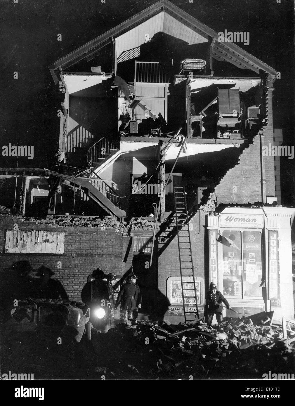 Bad Weather - a multi storey home is ripped open down a side wall after an earthquake revealing the houses floors and contents Stock Photo