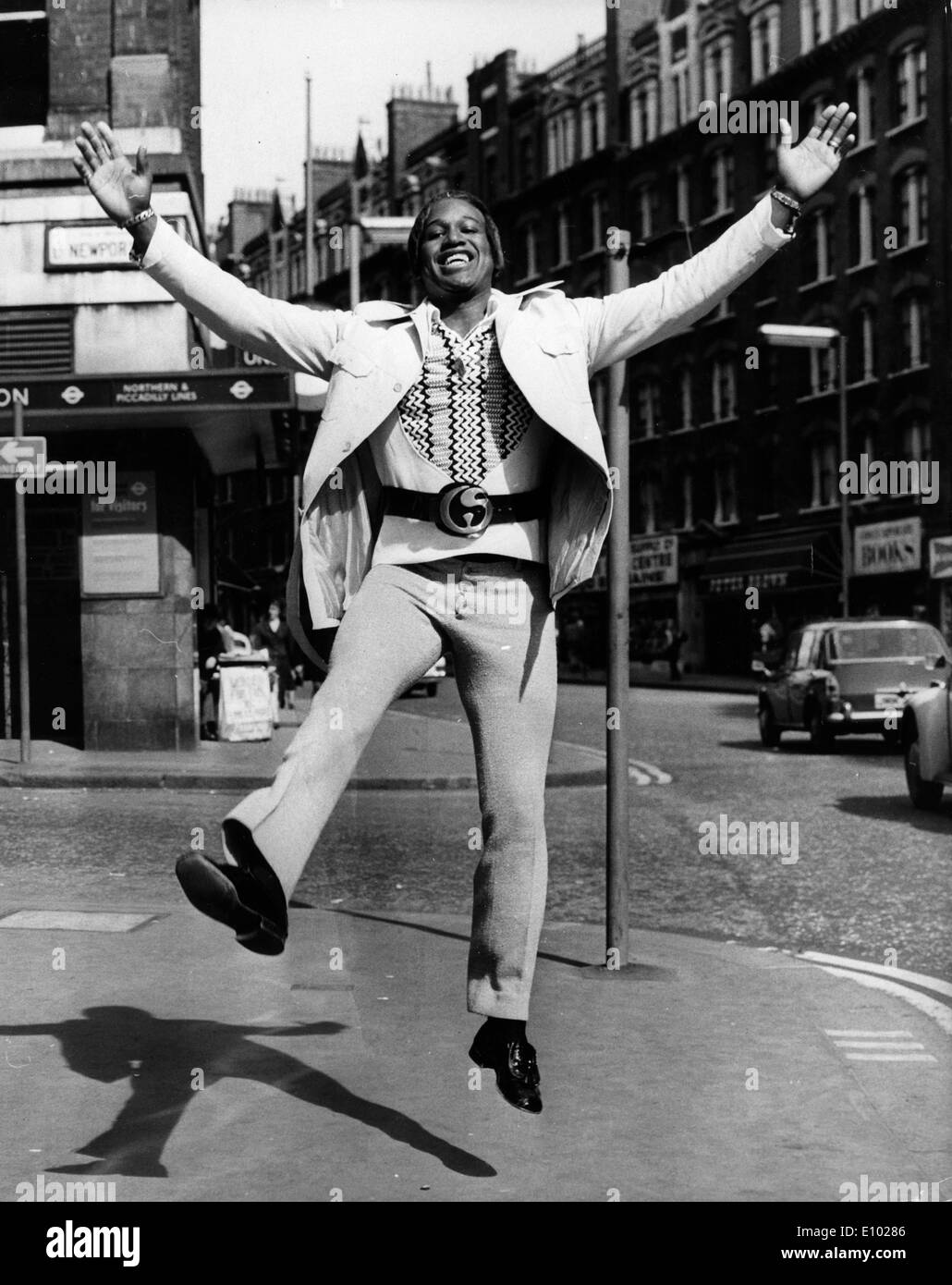 Singer Lovelace Watkins jumping in the street Stock Photo