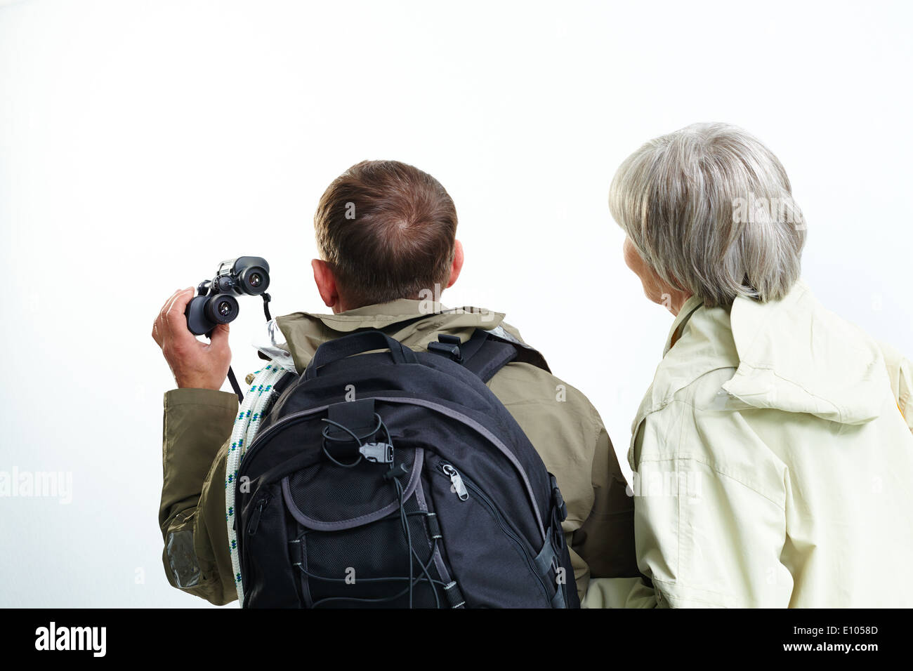Backs of senior hikers on trip Stock Photo