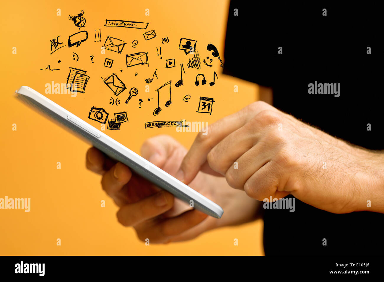 Male Hands with tablet computer and various doodle icons. Using modern technology gadgets. Stock Photo