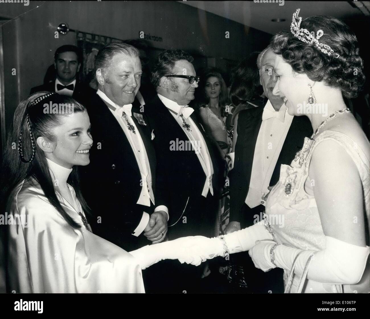 Feb. 02, 1970 - Royal Film Performance. H.M. The Queen talking to Genevieve Bujold, who plays Anne Boleyn in ''Anne of the Thousand Days'', before the Royal Film performance at the Odeon, Leicester Square, London, last night. In the background are Actor/Director Richard Attenborough (left) and Singer/Comedian Harry Secombe. The Royal Film Performance is in aid of the Cinema and Television Benevolent Fund. Stock Photo