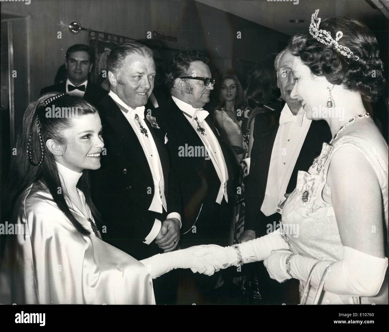 Feb. 02, 1970 - Royal film performance. H.M. The Queen talking to Genevieve Bujold, who plays Anne Boleyn in ''Anne of the Thousand Days'', before the Royal Film performance at the Odeon, Leicester Square, London, last night. In the background are Actor/Director Richard Attenborough (left) and Singer/Comedian Harry Secombe. The Royal Film Performance is in aid of the Cinema and Television Benevolent Fund. Stock Photo