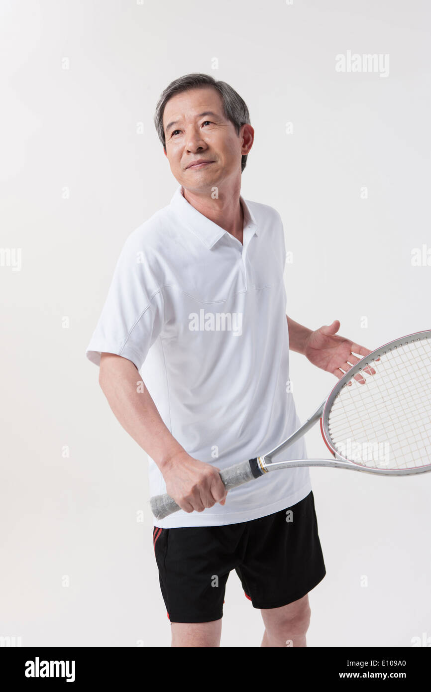 an old man playing tennis Stock Photo