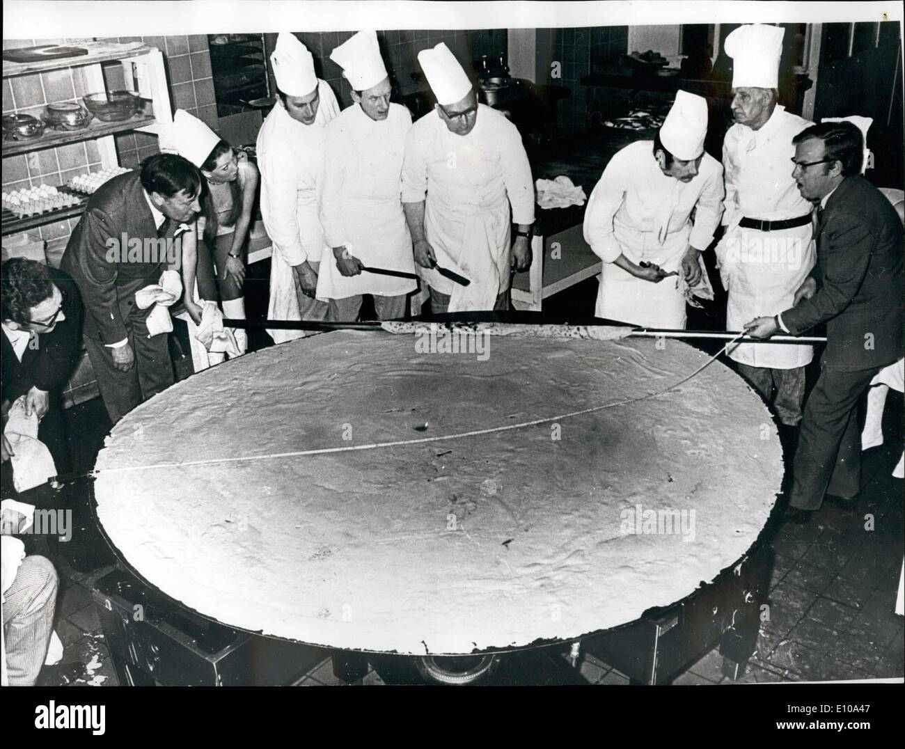 Feb. 17, 1972 - FEBRUARY 17th. 1972. ROW ABOUT THIS FOR A PANCAKE! Take 60 eggs, 30 pints of milk and 12 lbs of flour - and what have you got? Probably the worlds largest pancake, Measuring 8ft,lins and 25ft 2i ins in circumference, it was made at the Palace Hotel, Torquay, by the head chef, Mr, Henry Garrieh, and it is hoped to have it in the Guinness Book of Records as the world!s largest pancake. Mr, Garriek had the help of five other chefs at the hotel to produce the monster pancake, seen here being measured Stock Photo