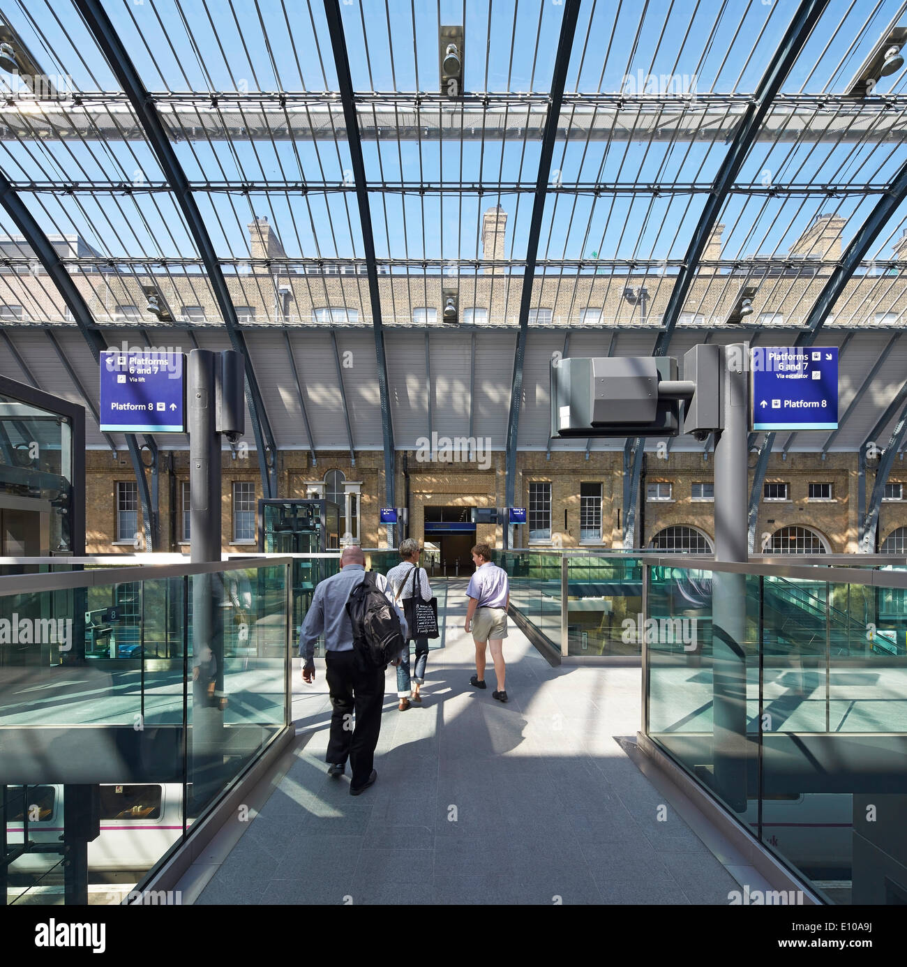 King's Cross trainshed, London, United Kingdom. Architect: Network Rail, 2013. Elevated linking walkways under glass roof. Stock Photo