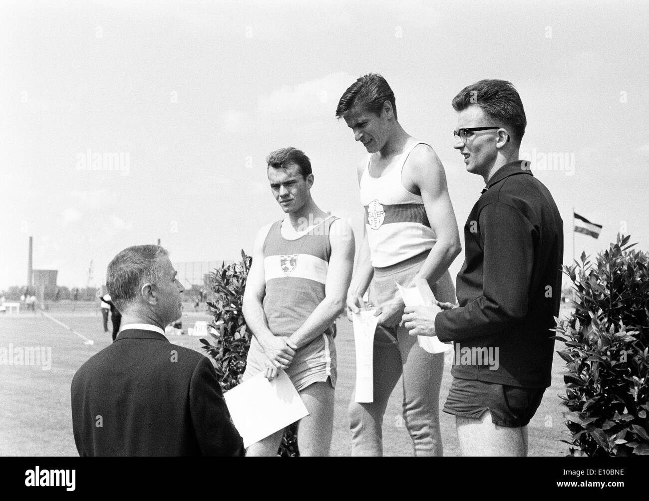 Sixties, black and white photo, sports, Athletics, sports meeting 1965 in Gelsenkirchen-Buer, track racing, hurdling, men, hurdler, victory ceremony, right Fritz Roth of ASC Darmstadt, 2.f.r. Ferdinand Haas of Bayer Leverkusen, D-Gelsenkirchen, D-Gelsenki Stock Photo