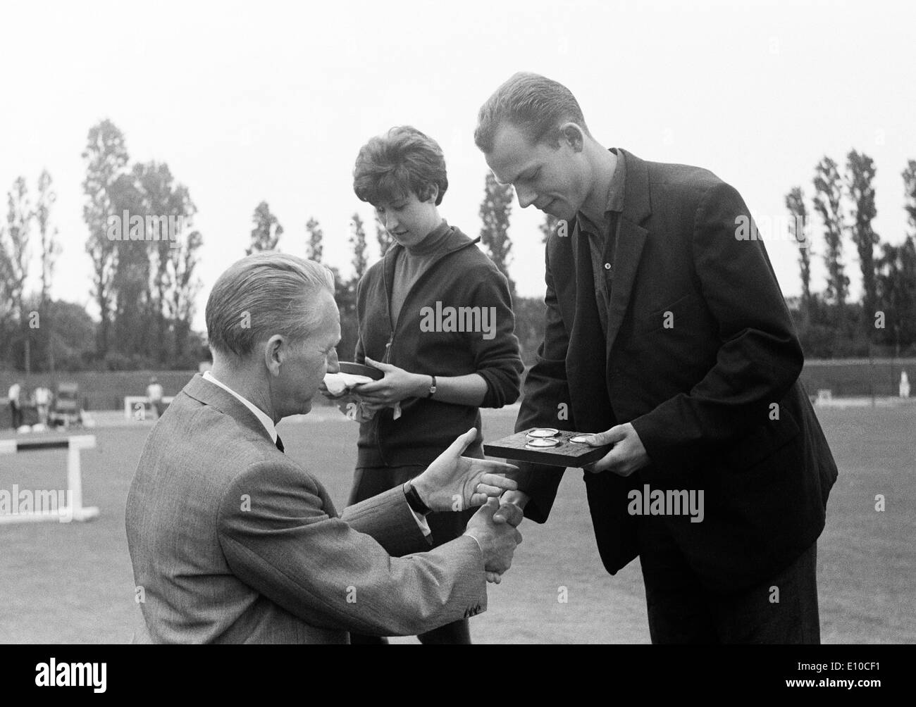 Sixties, black and white photo, sports, athletics, Juniors Lower Rhine Championships in Athletics 1966 in the Jahn Stadium in Bottrop, victory ceremony and presentation of pices by chief municipal director Werner Gareiss, D-Bottrop, Ruhr area, North Rhine Stock Photo