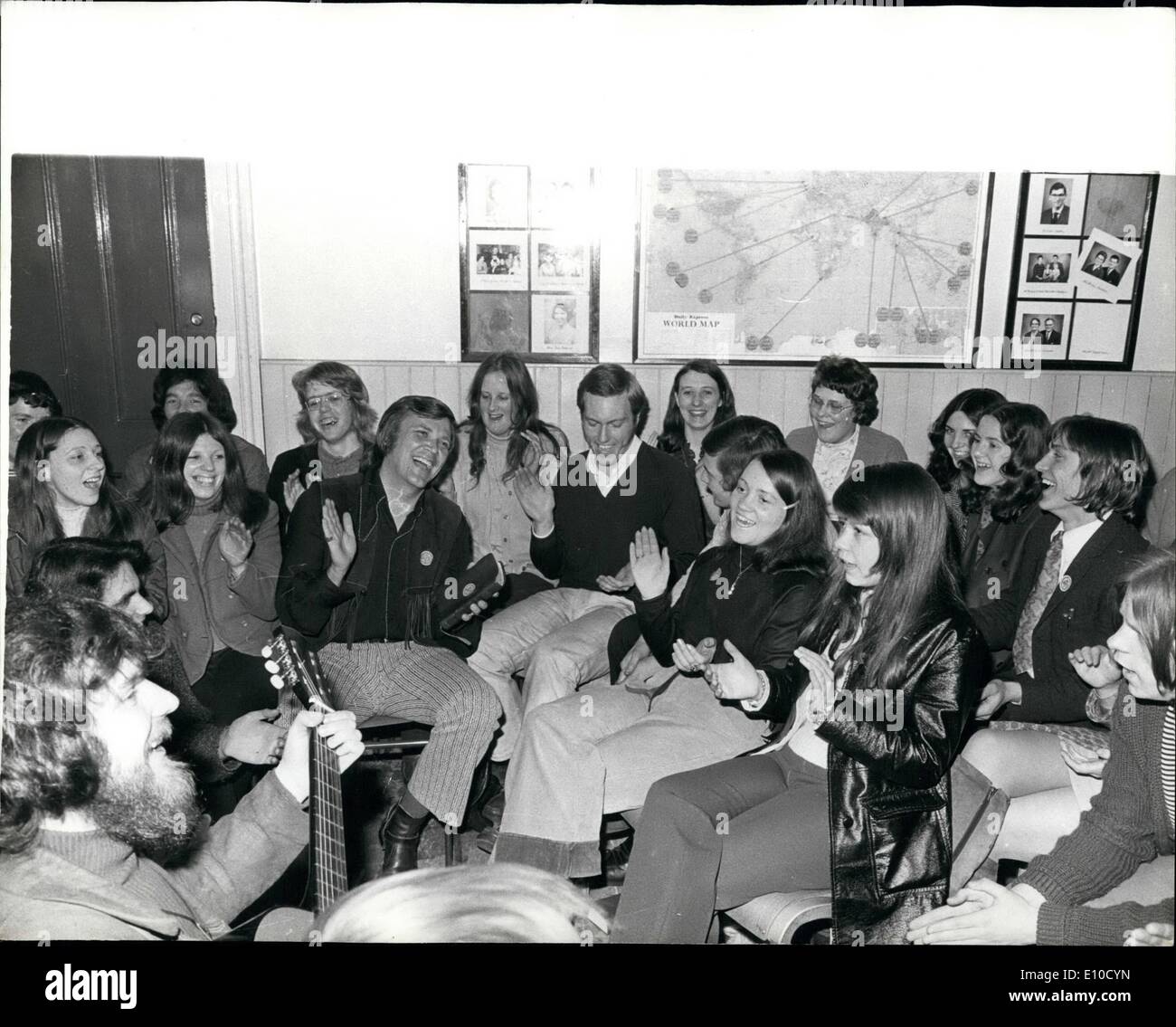 Apr. 09, 1972 - April 9th - 1972, Leader of the Californian Jesus Movement in Glasgow. Photo shows following a ''Pray-in'' at the Adelaide Baptist Church, Glasgow, Arthur. Blessitt, Leader of the Californian Jesus Movement (Centre) joins young followers for a song in the basement. Stock Photo