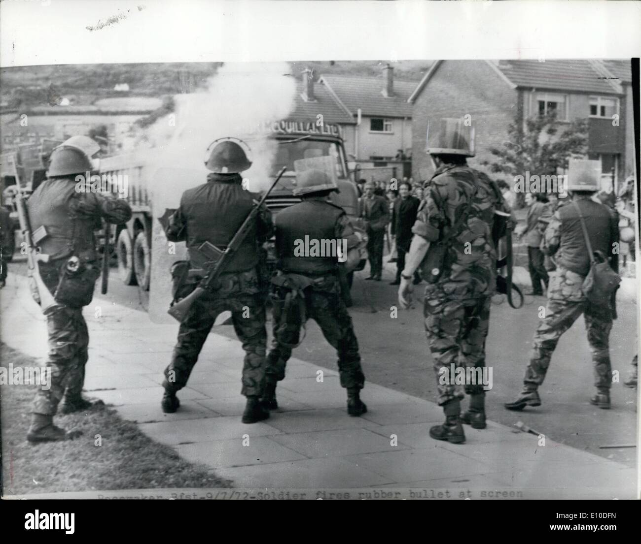 Jul. 07, 1972 - PROVISIONAL IRA CALLS OFF CEASEFIRE. Claiming that troops had broken the trucks a few hours earlier by firing rubber bullets and CS gas get Catholics on the Lenadoon eatate in Belfast, the Provisional IRA called off their two-week old Ulster ceasefire. PHOTO SHOWS: CS gas rises a soldier fires a rubber bullet at lorry carrying furniture which was heading a group of several hundred Catholic in Lenadoon district of Belfast. The crowd were attempting to install Catholics families in vacant houses. Stock Photo