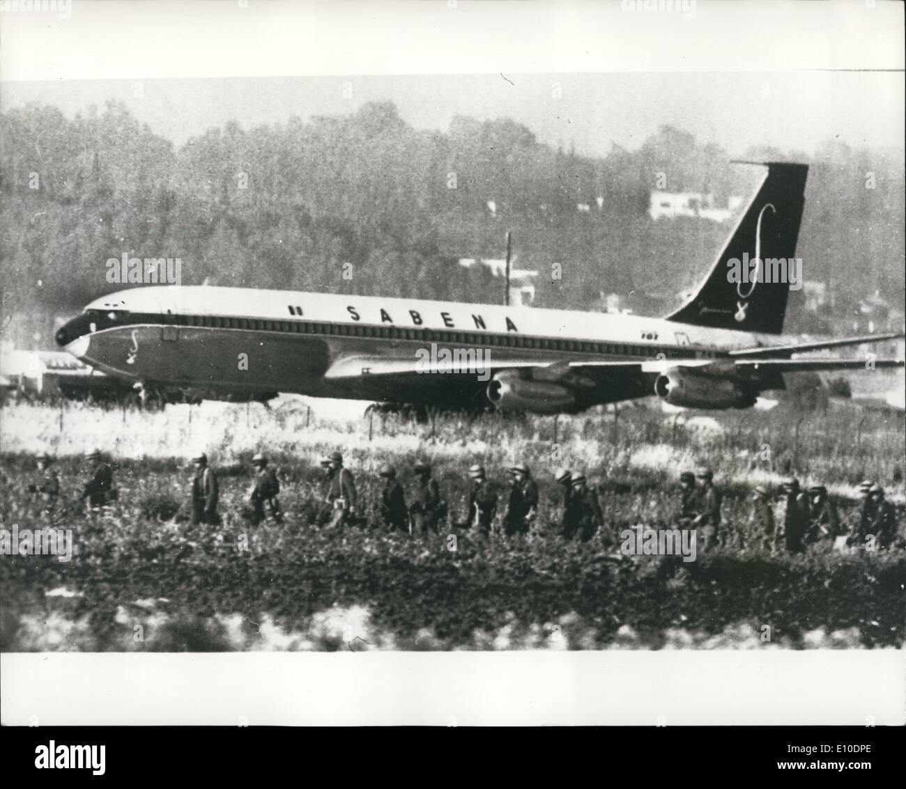 May 05, 1972 - Two Boeing hijacked shot dead: All the 100 passengers on the hi jacked Boeing 707 of Sabena Airliner are safe after two of the hijackers had been shot dead today - and two others wounded. The jet was seized last night by four Arabs, armed with pistols and grenades, after leaving Vienna, a stopping point on a flight from Brussels to Tel Aviv. Photo Shows This picture just received by radio, shows soldiers surrounding the hijacked aircraft at Lod Airport, Tel Aviv. Stock Photo