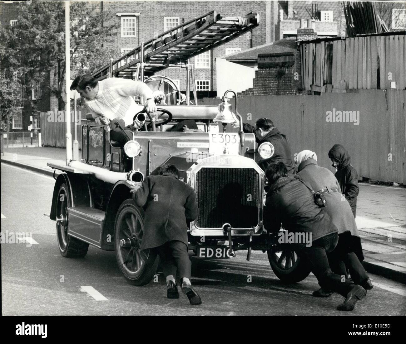 May 05, 1972 - Historic commercial vehicle club run from London to Brighton : About 180 vehicles took part in this year's historic commercial vehicle club run from battersea park, London , to Brighton. Among the vehicles taking part were vintage fire engines, vans, trucks, buses, coaches and a steam tractor. photo shows An early casualty during the run to Brighton today was this Dennis N-Type fire engine, built in 1914. Members of the public give the vehicle a push to get started again in Streatham. Stock Photo