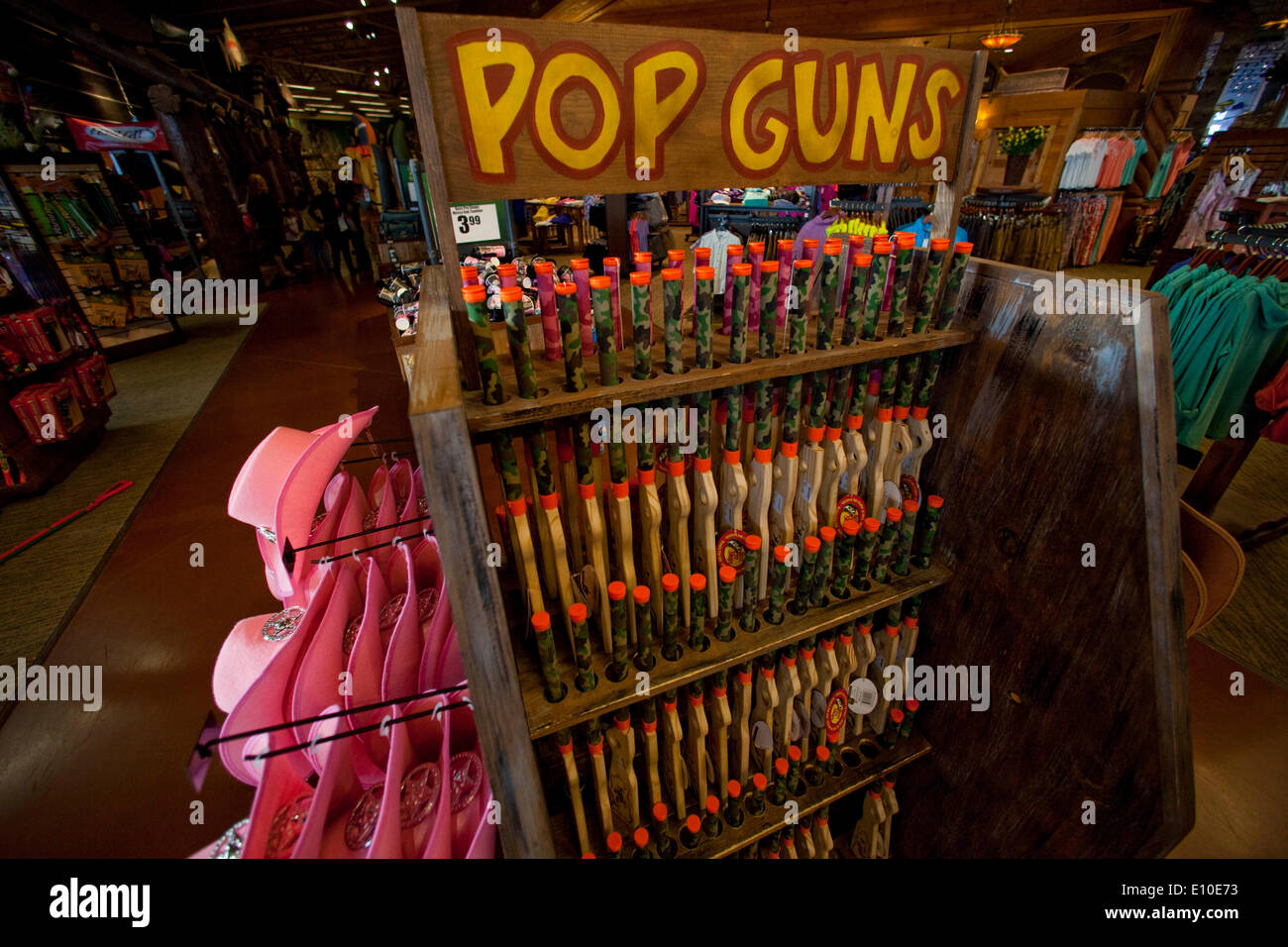 May 18, 2014 - Riverside, California, U.S. - Wooden toy pop guns for kids on sale beside pink cowgirl stetson hats in a large Bass Pro Shops store in Riverside. Bass Pro Shops (Outdoor World) is a privately held retailer of hunting, fishing, camping and related outdoor recreation merchandise. Bass Pro Shops is known for a large selection of hunting, fishing, and other outdoor gear. (Credit Image: © Ruaridh Stewart/ZUMA Wire/ZUMAPRESS.com) Stock Photo