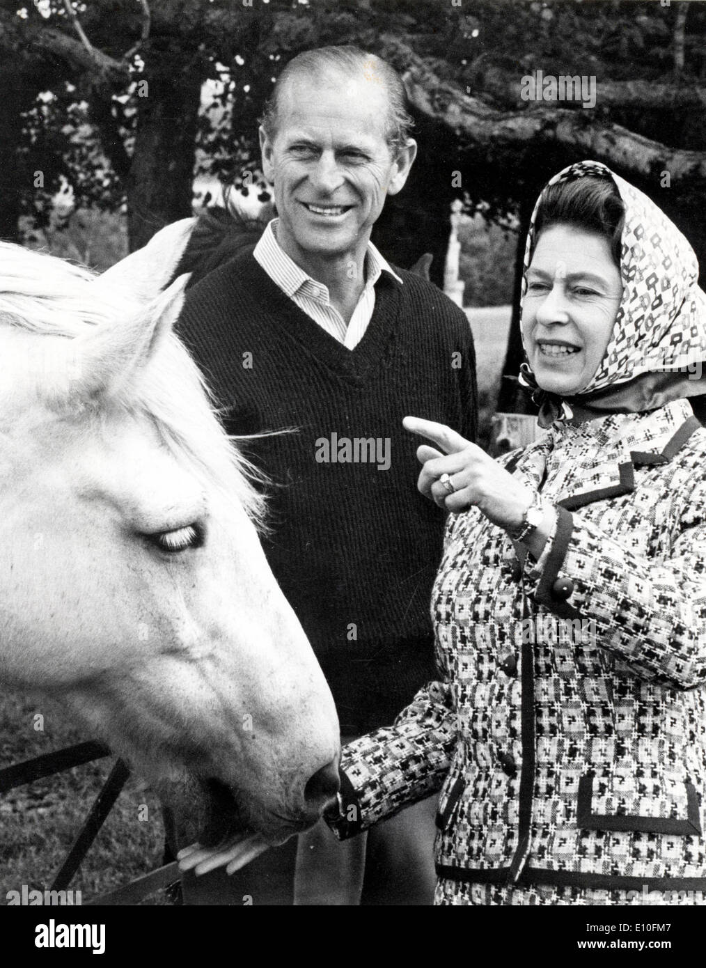 Queen Elizabeth II and Prince Philip pet a horse Stock Photo