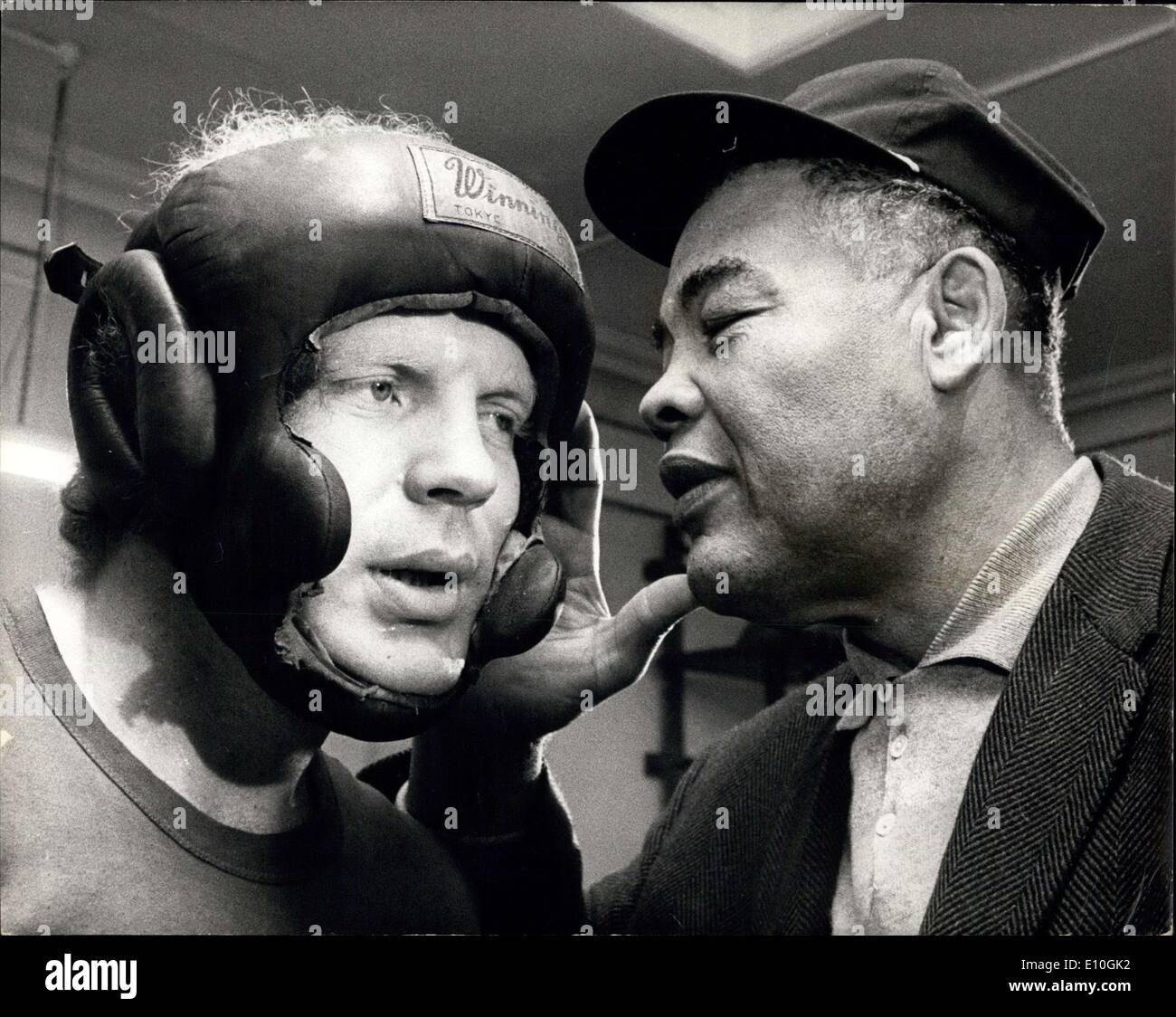 Jan. 11, 1973 - Joe Louis in Town. Mahammad Ali was coming to London to watch Britain's Joe Bugner defend his European heavyweight title against Holland' Rudi Lubbers at the Royal Albert Hall on January 16th. But Muhammad had to cancel his visit, to Joe Louis, former would heavyweight champion has come instead. The two Joes - Louis and Bugner went along to the British Boxing Board of Control's gymnasium, Haverstock Hill, to watch Lubbers in training today. Photo shows Joe Louis, the famous former former world champion, whispers into the ear of Rudi Lubbers, during today's training session. Stock Photo