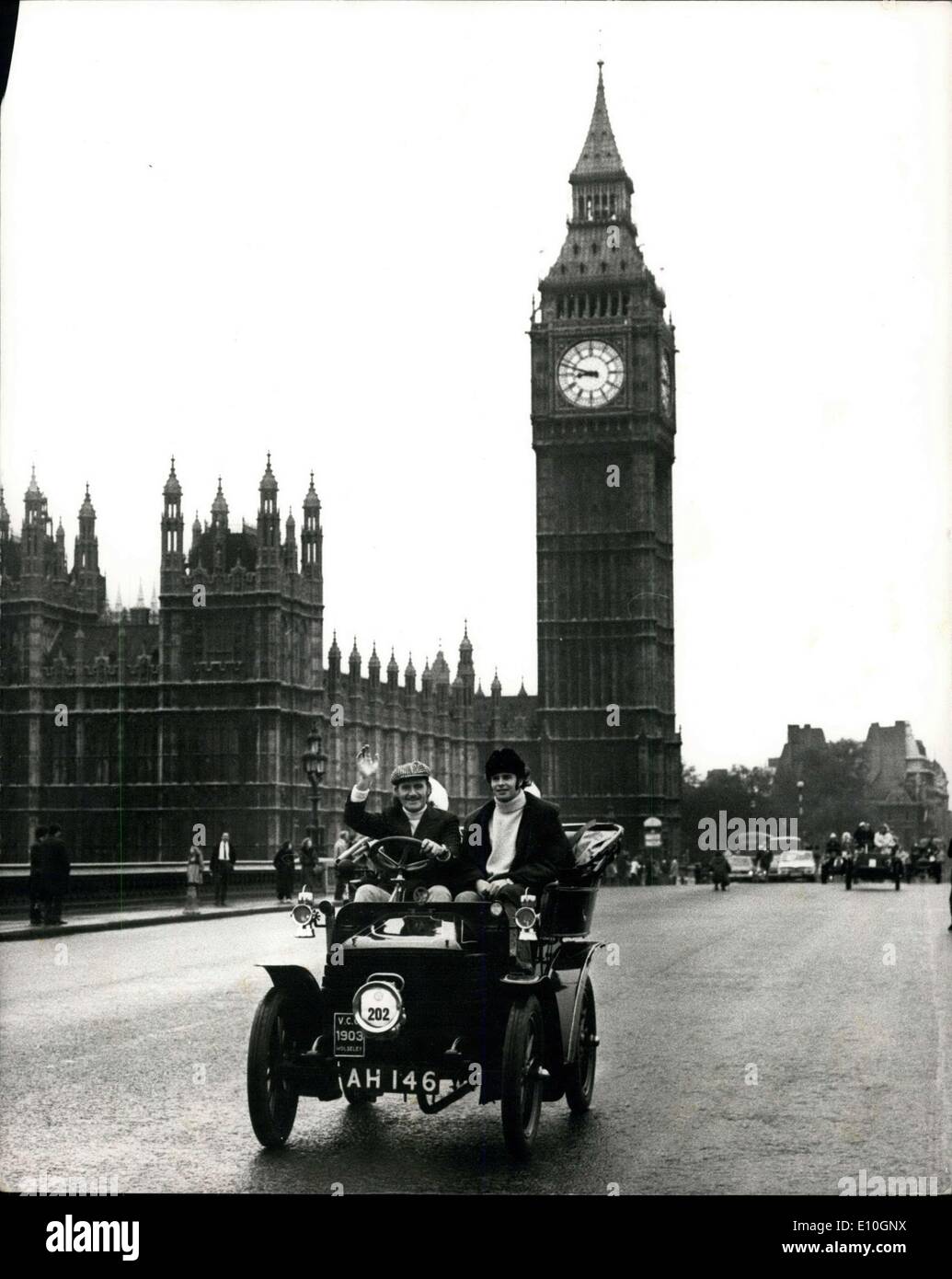 Nov. 05, 1972 - London-Brighton Veteran Car Run ? The annual London to Brighton Veteran Car Run took place today, 250 car from 15 countries took part. Photo Shows: Racing driver Graham Hill gives a wave as he comes across Westminster Bridge driving 1903 Wolsey. The two passengers are actress Dora Bryan and singer Penny Lane. AM/Keystone Stock Photo