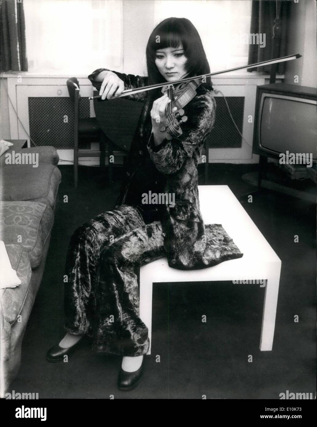 May 05, 1973 - Japanese Violinist In London For Concerts: There was a photo call today for Tokyo-born Teiko Maehshi, who is here to make her London debut in two concerts with the Royal Philharmonic Orchestra, conducted by Rudolf Kempe, The first will be at Fairfield Hall, Croydon, on May 19th, and the second at the Festival Hal on May 20. Her London debut will followed by concerts in Italy and Germany. Photo Shows: Teiko Maehashi seen practising on her violin, during today's photocall in London. Stock Photo