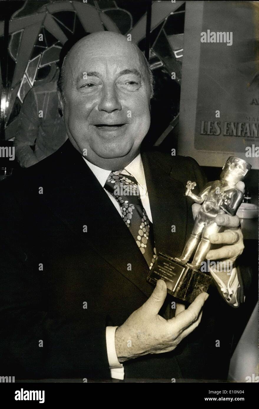 Jun. 30, 1973 - During a party held in a private Parisian club in honor of Marcel Carne, the famous movie producer was given ''The Recognition Prize,'' presented by all the movie goers to the author of ''Children of Paradise''. Here, Carne shows off his gold and silver trophy, a faithful reproduction of a ancient pre-Columbian idol representing the ''God of Power' Stock Photo