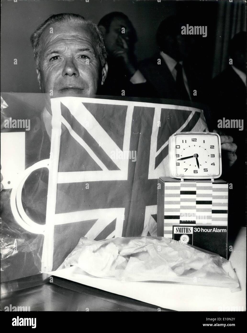 Aug. 08, 1973 - Scotland Yard press conferences on Baker Street bomb; A plastic explosive bomb timed to explode at 5:40 in the rush, was found last night in the booking hall of Baker Street underground railway station. The bomb was in a Union Jack plastic carrier bag and comprised an alarm clock and battery wired to a parcel. Photo Shows Commander Huntler, in charge of the Scotland Yard serious crime squad, pictured at today's Press conference with the original wrapping paper and carrier bag in which the Baker Street station bomb was contained - and replicas of the clock and the box it was in Stock Photo